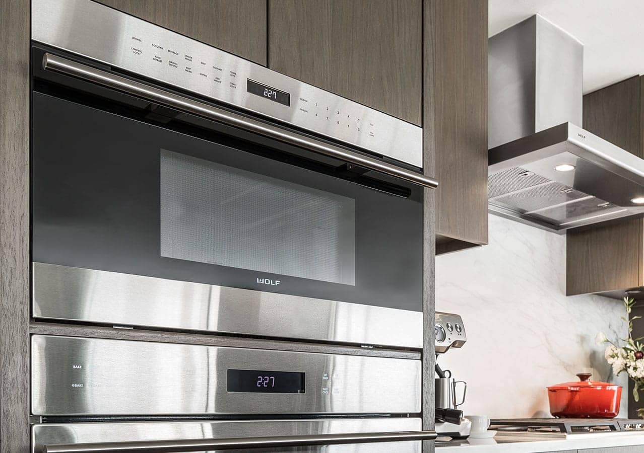 Built-in Wolf oven and stainless steel kitchen appliances inside a luxury residence at 1535 Howe Vancouver by Onni located at 1335 Howe Street in Downtown Vancouver.