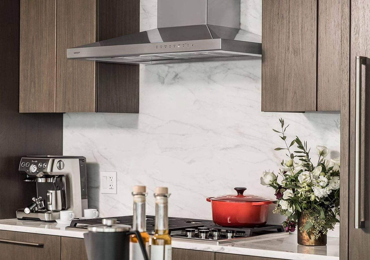 Designer kitchen at 1535 Howe Vancouver featuring marble backsplash, Wolf cooktop, espresso station, and modern cabinetry within a luxury Downtown Vancouver residence at 1335 Howe Street.