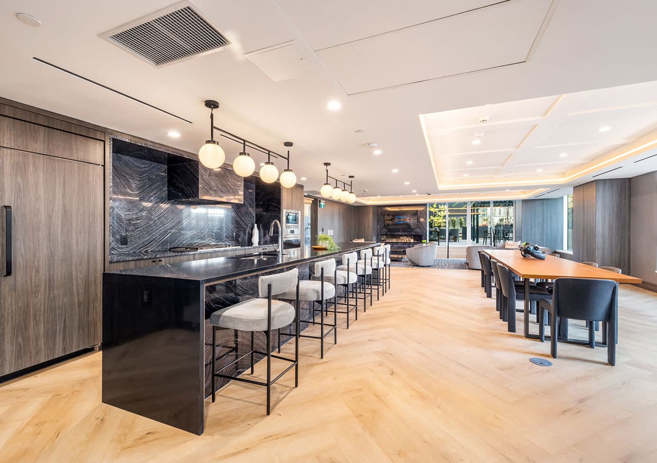Entertainment lounge at 1535 Howe Vancouver featuring bar seating, dining tables, fireplace, and upscale finishes within the amenity area at 1335 Howe Street in Downtown Vancouver.
