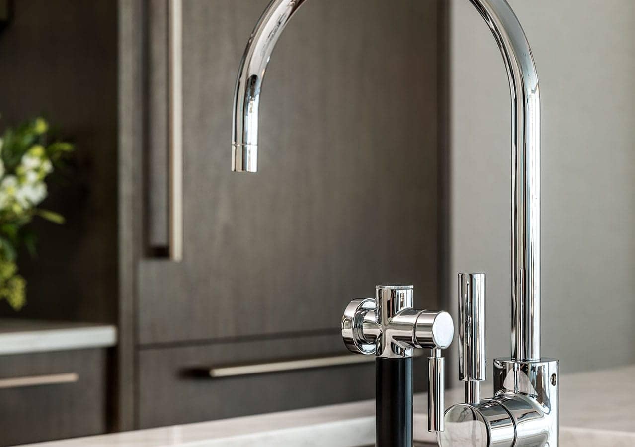 Detailed view of modern chrome kitchen faucet and premium fixtures inside a luxury residence at 1535 Howe Vancouver by Onni located at 1335 Howe Street in Downtown Vancouver.
