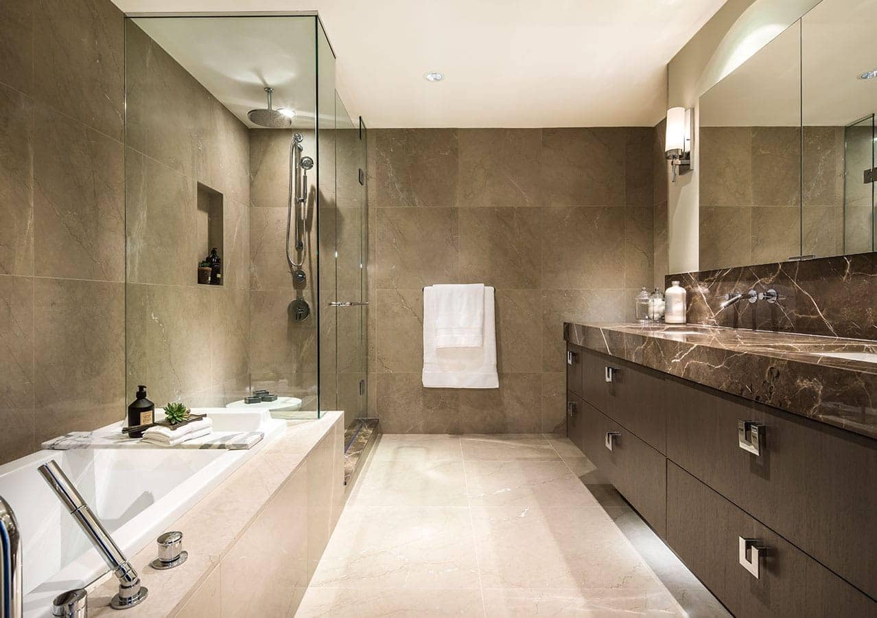 Luxury bathroom at 1535 Howe Vancouver by Onni with stone tile surfaces, glass shower, custom vanity, and contemporary lighting at 1335 Howe Street in Downtown Vancouver.