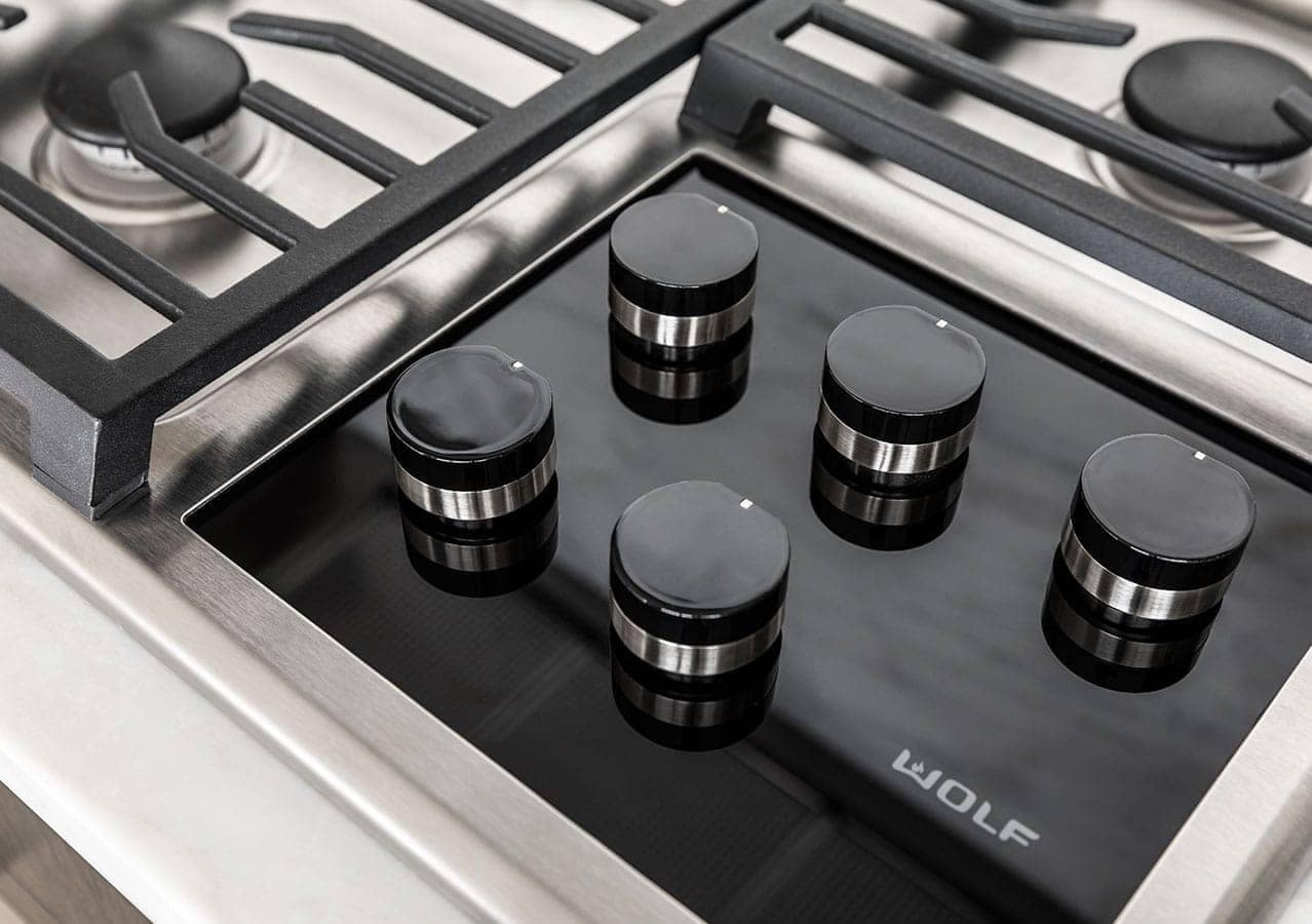 Wolf gas cooktop appliance detail inside a luxury kitchen at 1535 Howe Vancouver by Onni featuring premium culinary appliances and modern finishes at 1335 Howe Street Downtown Vancouver.