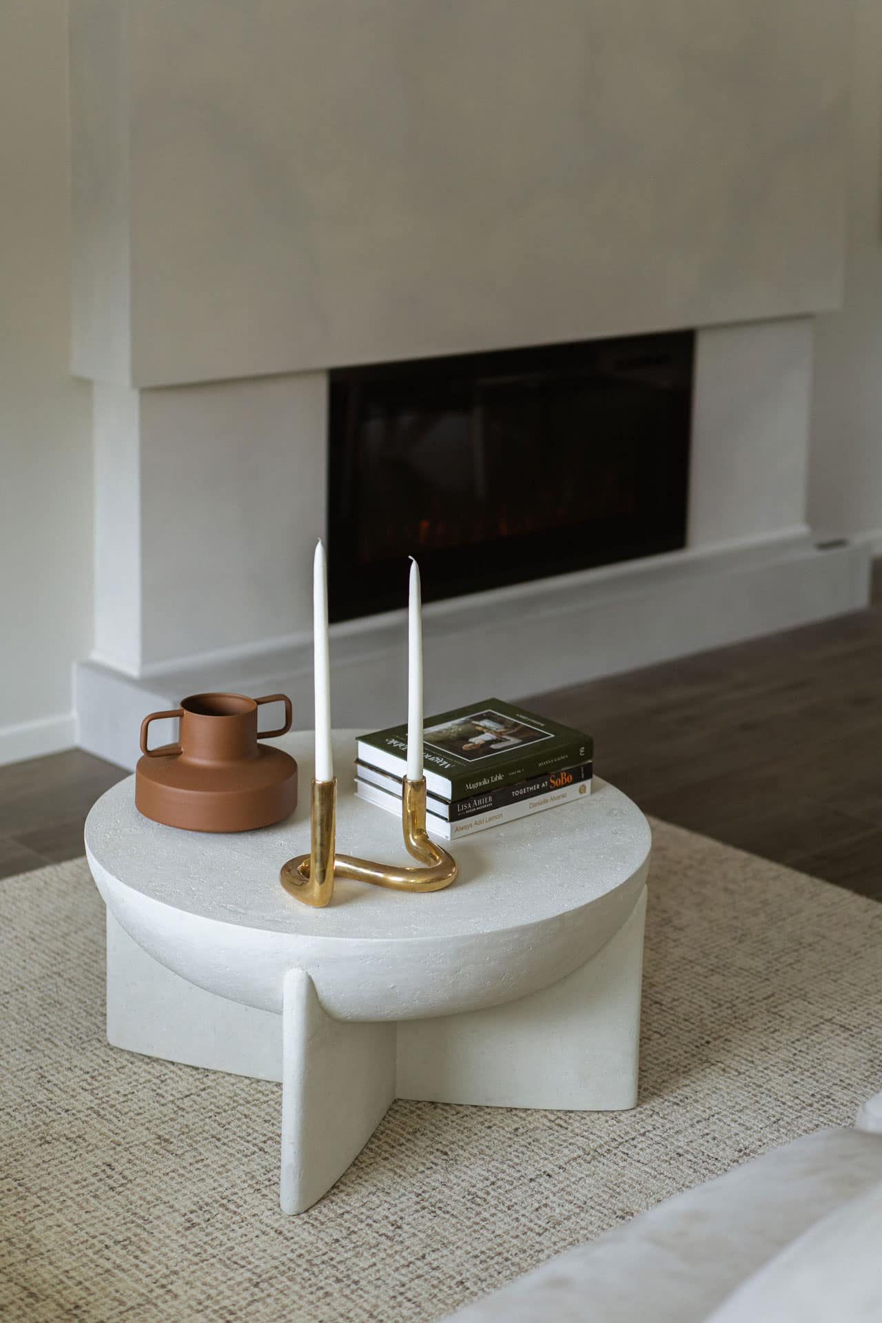 Living room detail at Fox & Aikins South Surrey townhomes by Park Ridge Homes, 1871 165A Street, featuring a contemporary fireplace, neutral wall tones, modern coffee table styling, and wide plank flooring in an open-concept layout.