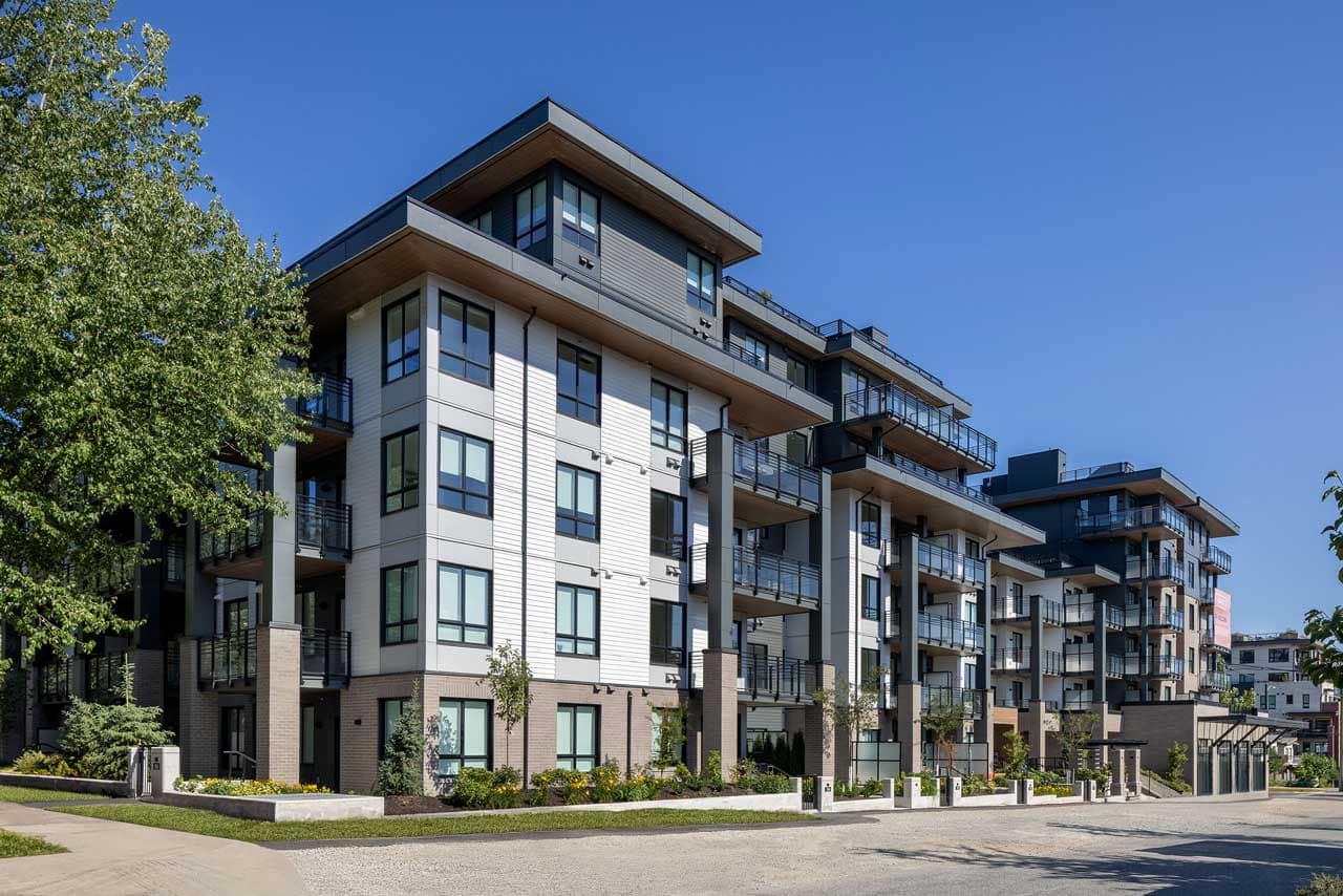 Contemporary exterior of Grafia Vancouver, a presale condominium development by Porte Homes at 2406 Garden Drive in Vancouver, showcasing modern West Coast architecture with spacious balconies, landscaped grounds, and clean architectural lines on a sunny day.