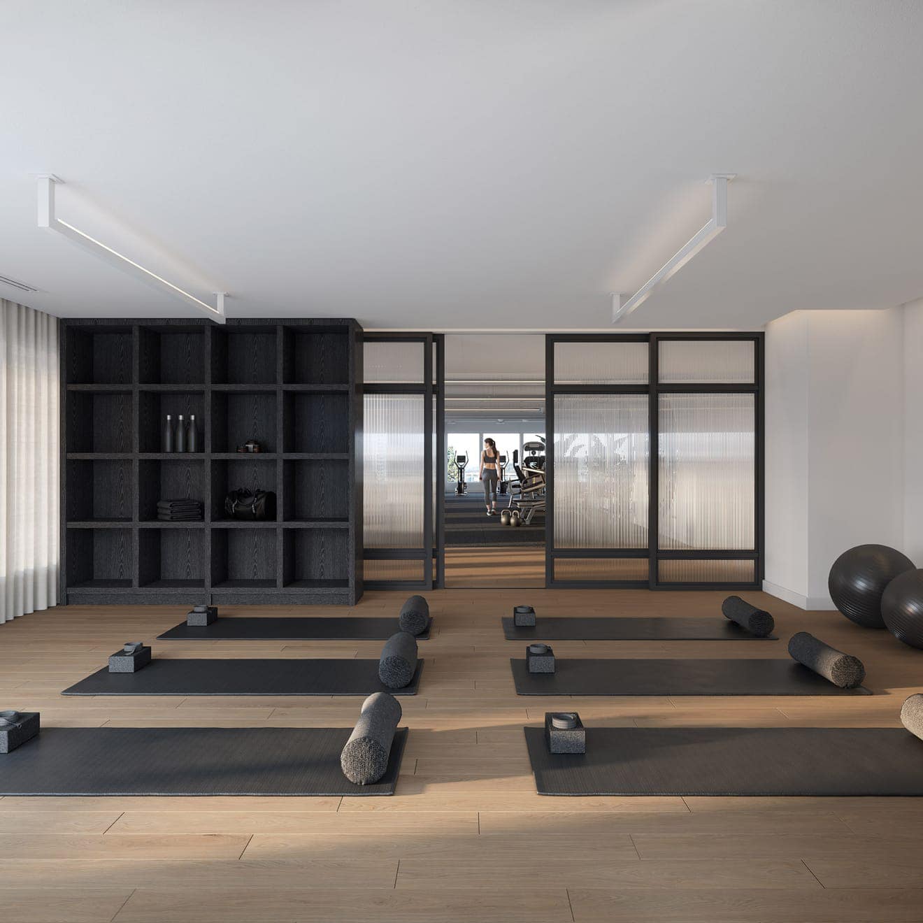 Yoga and wellness studio at Smith & Farrow presale in Coquitlam West by Boffo Developments, located at 720 Farrow Street, featuring wood flooring, dedicated storage, serene design, and views toward the fully equipped fitness centre.