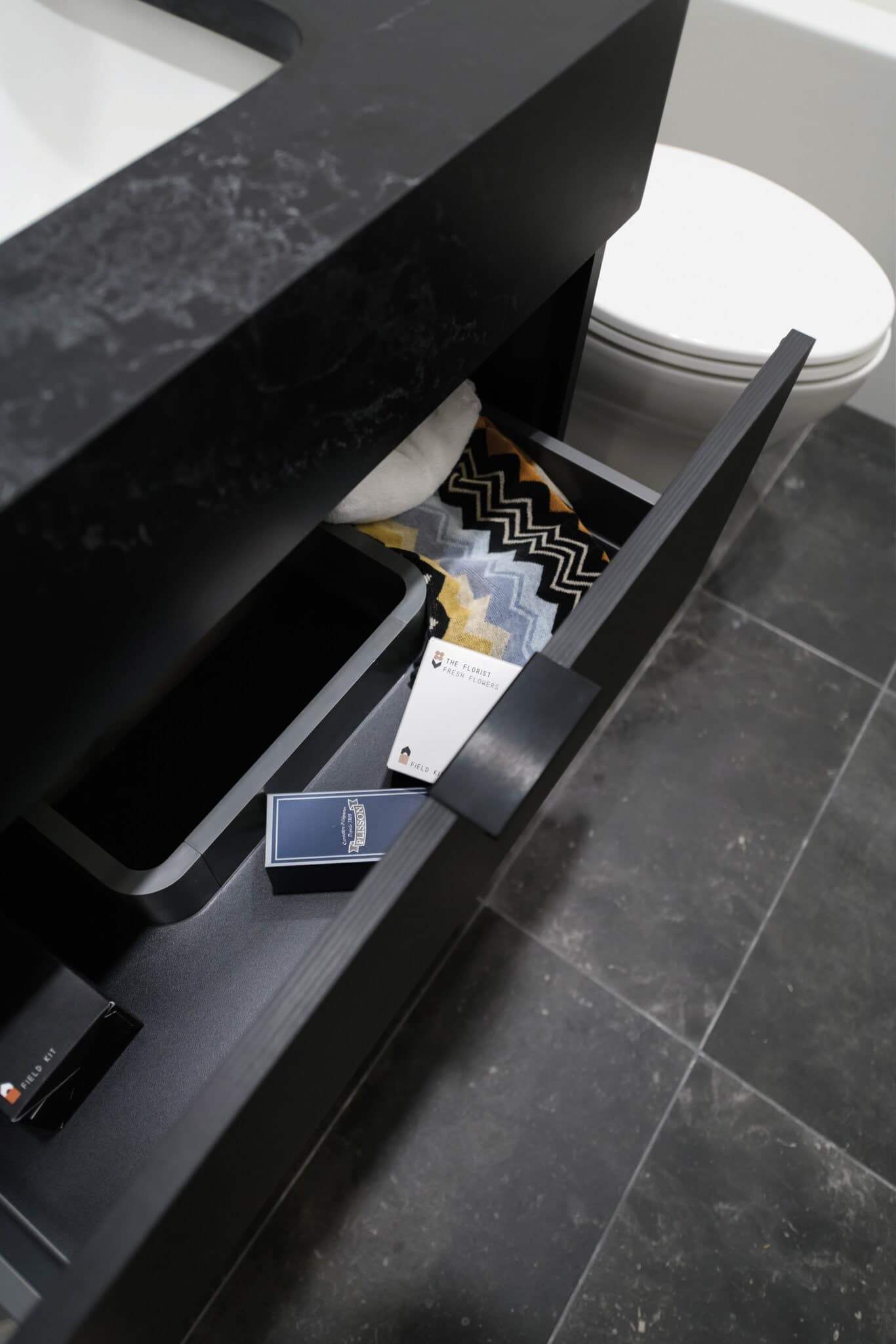 Vanity drawer detail showing organized storage in Reign Metrotown bathrooms.