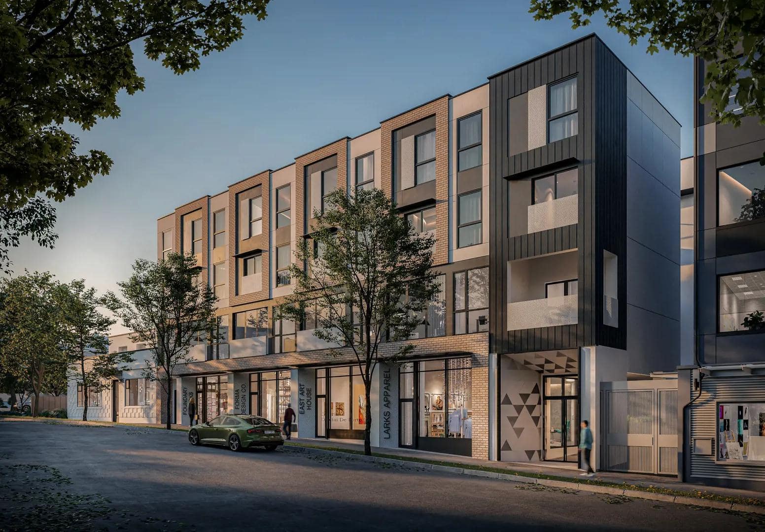 Angled exterior view of Hendry presale development in East Vancouver, showing modern brick and metal façade, private balconies, street-level shops, and tree-lined Commercial Street at 3839 Commercial Street by Trillium Projects.