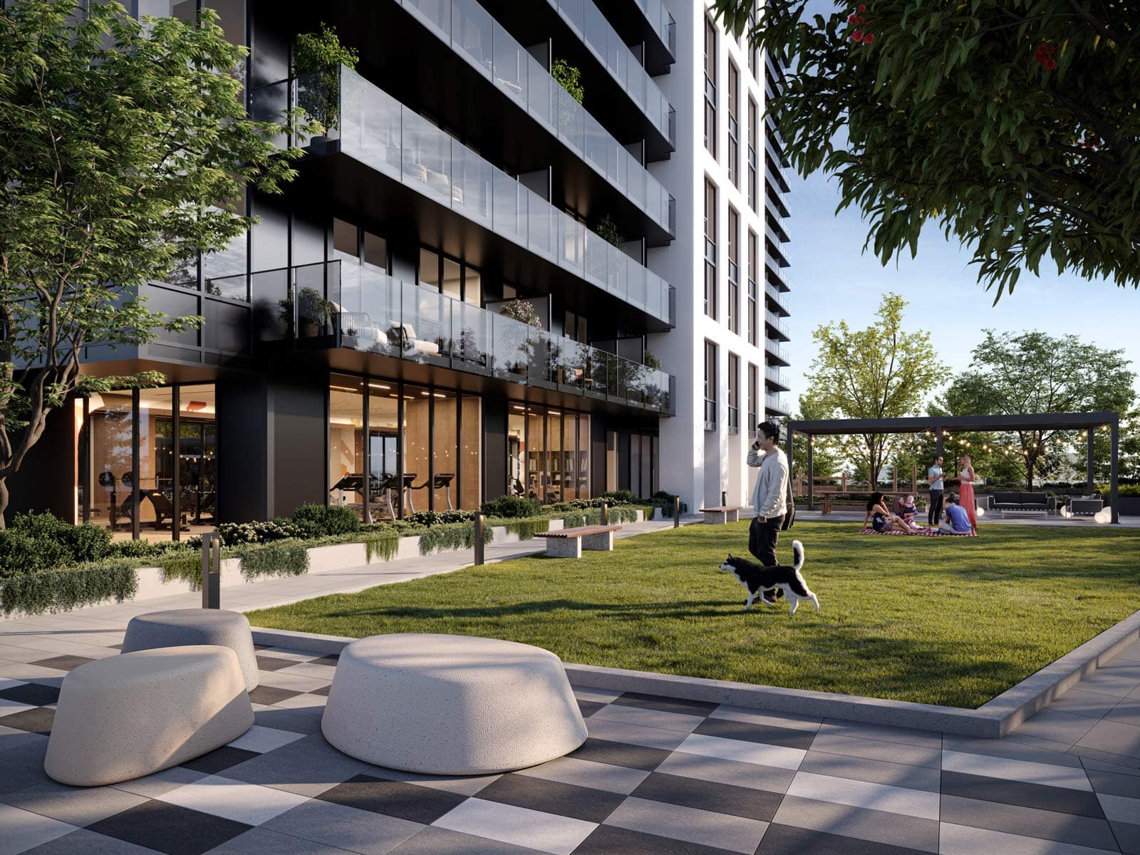 Landscaped courtyard at Town & Centre by Mosaic at 3650 Westwood Street with green lawn, seating, and outdoor pathways in Coquitlam Town Centre