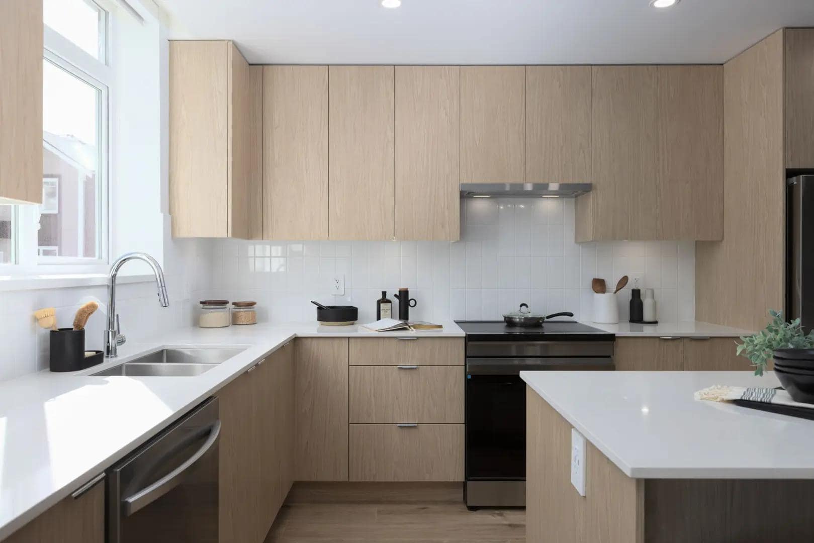 Modern bathroom interior at Chelsea at The Boroughs presale townhomes in Surreyโs Sunnyside Heights neighbourhood by Northwest Development at 16325 21 Avenue, featuring a double vanity with wood cabinetry, large mirror, quartz countertop, glass walk-in shower, and contemporary lighting.