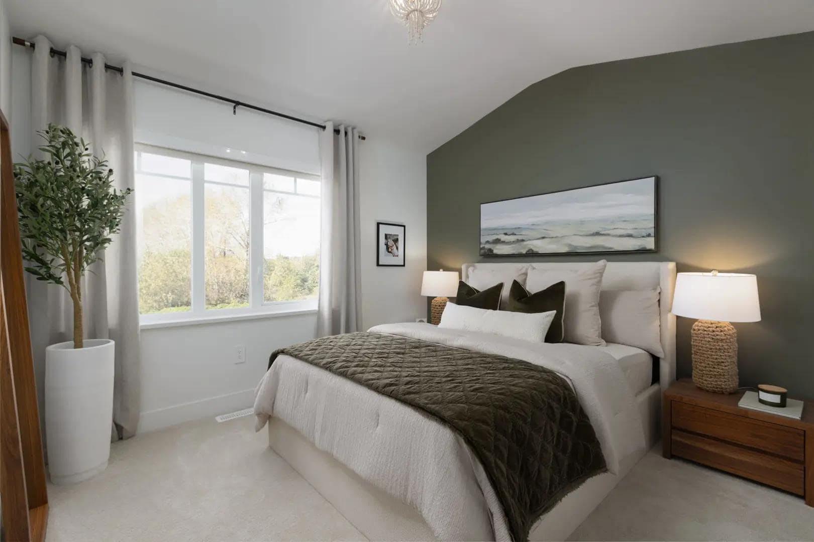 Primary bedroom interior at Chelsea at The Boroughs presale townhomes in Surreyโs Sunnyside Heights neighbourhood by Northwest Development at 16325 21 Avenue, featuring a large window, soft neutral dรฉcor, accent wall, and modern furnishings designed for a calm and comfortable living space.