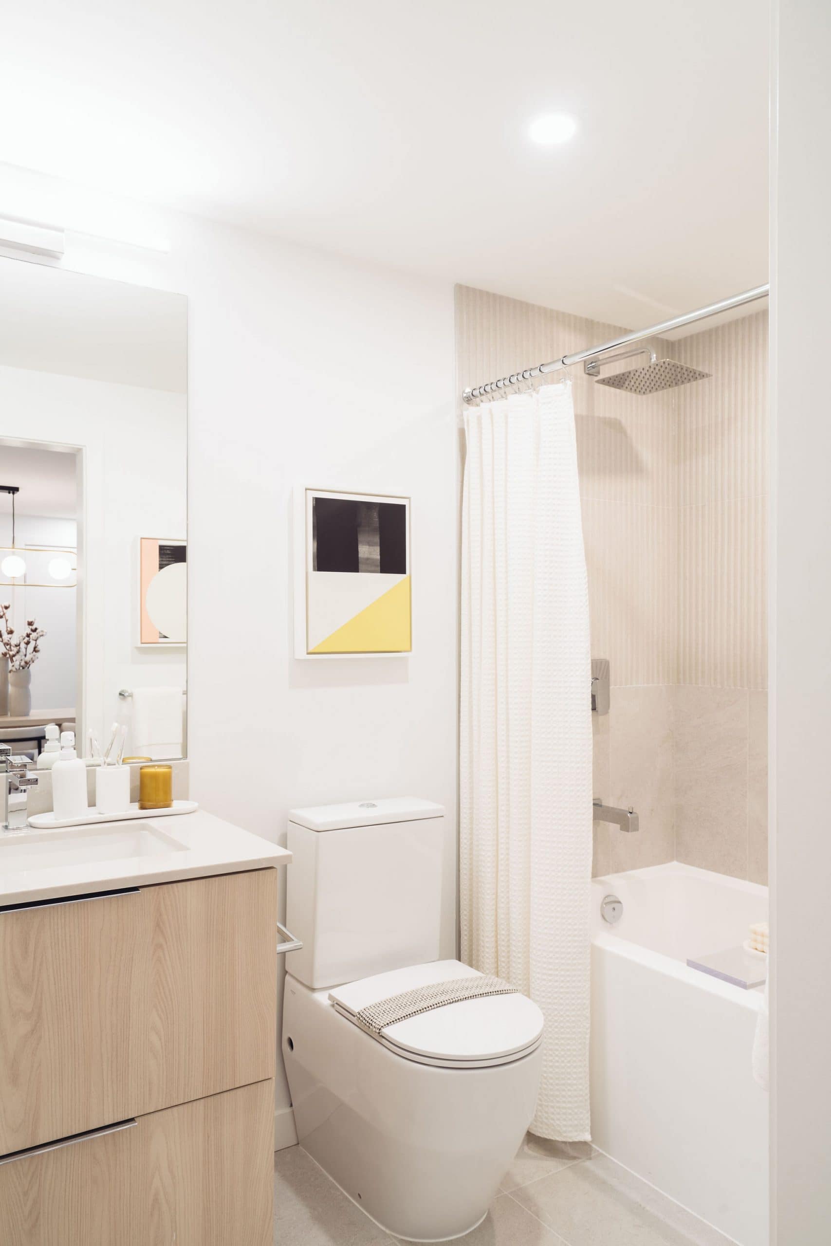 Contemporary bathroom with bathtub and shower combination at Soco Two Coquitlam presale development by Anthem at 311 Alderson Ave in Coquitlam’s Maillardville neighbourhood featuring a white bathtub