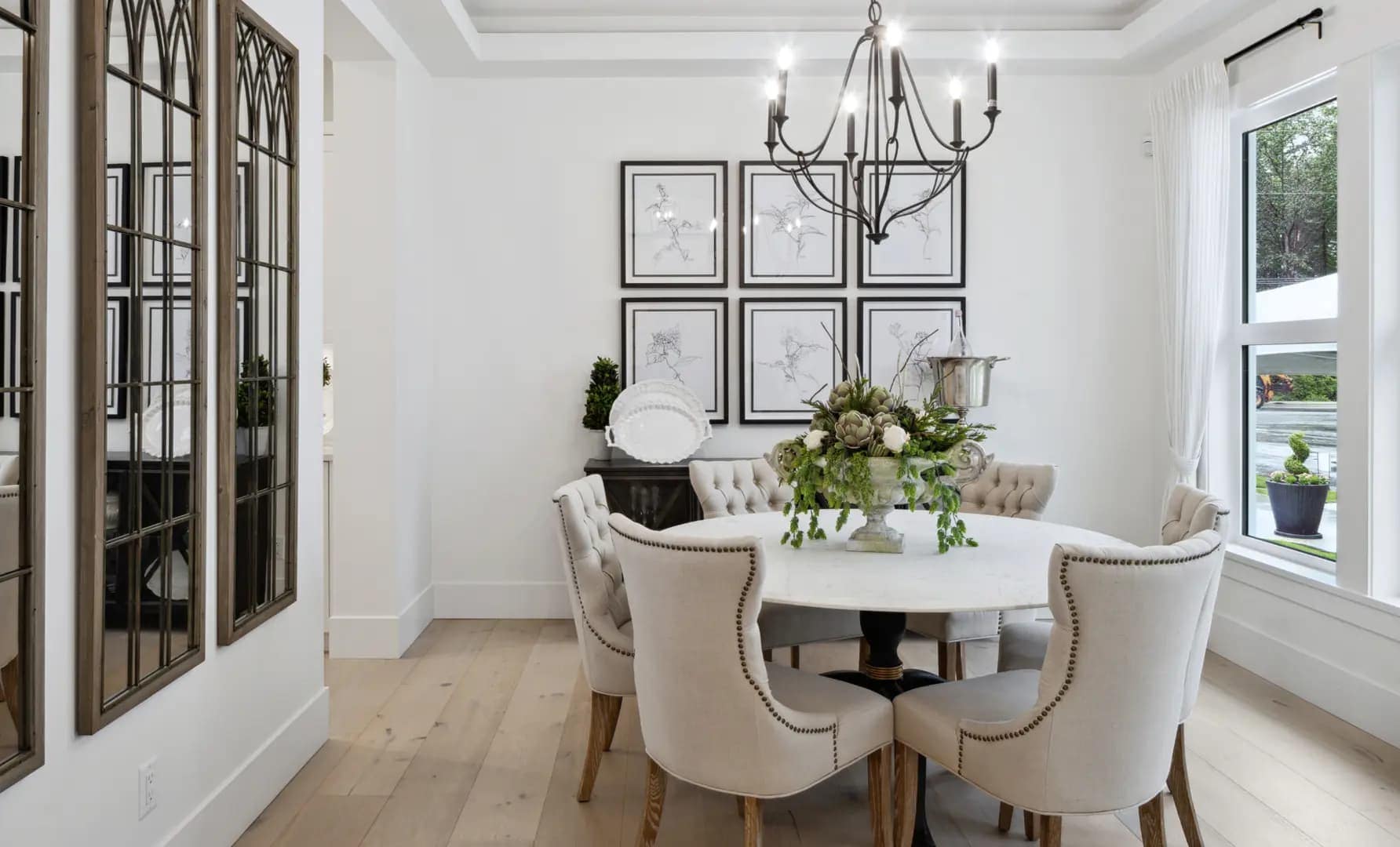 Elegant dining room at Brookswood Estates Langley by Foxridge Homes with chandelier lighting, hardwood flooring, and contemporary neutral dรฉcor.