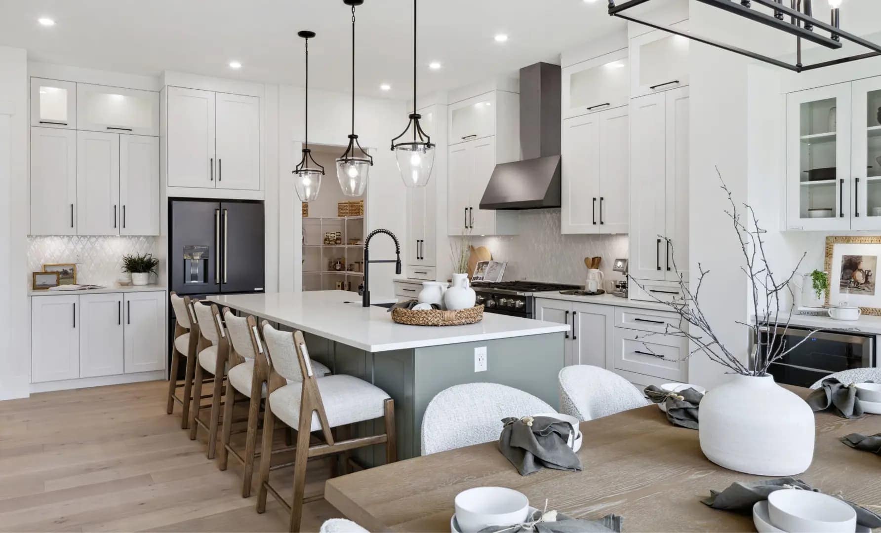 Open-concept kitchen and dining area at Brookswood Estates Langley by Foxridge Homes featuring a large island, pendant lighting, and spacious family layout.