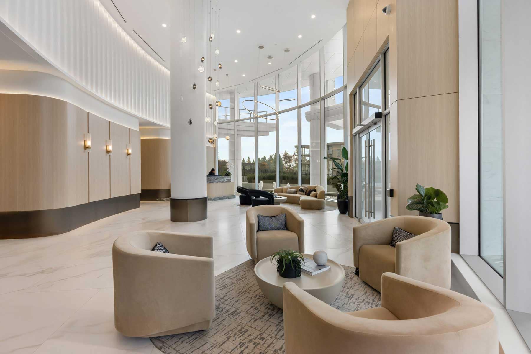 Double-height lobby at Icon at Southgate City Burnaby by Ledingham McAllister featuring concierge service, modern seating areas, and elegant architectural details.
