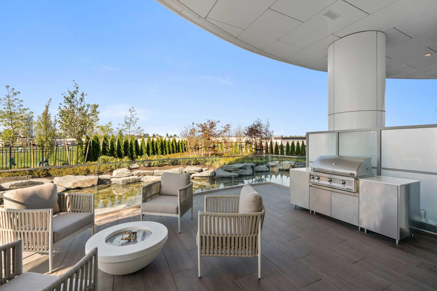 Outdoor BBQ and lounge area at Icon at Southgate City Burnaby overlooking landscaped ponds and gathering spaces at 7201 11th Avenue.