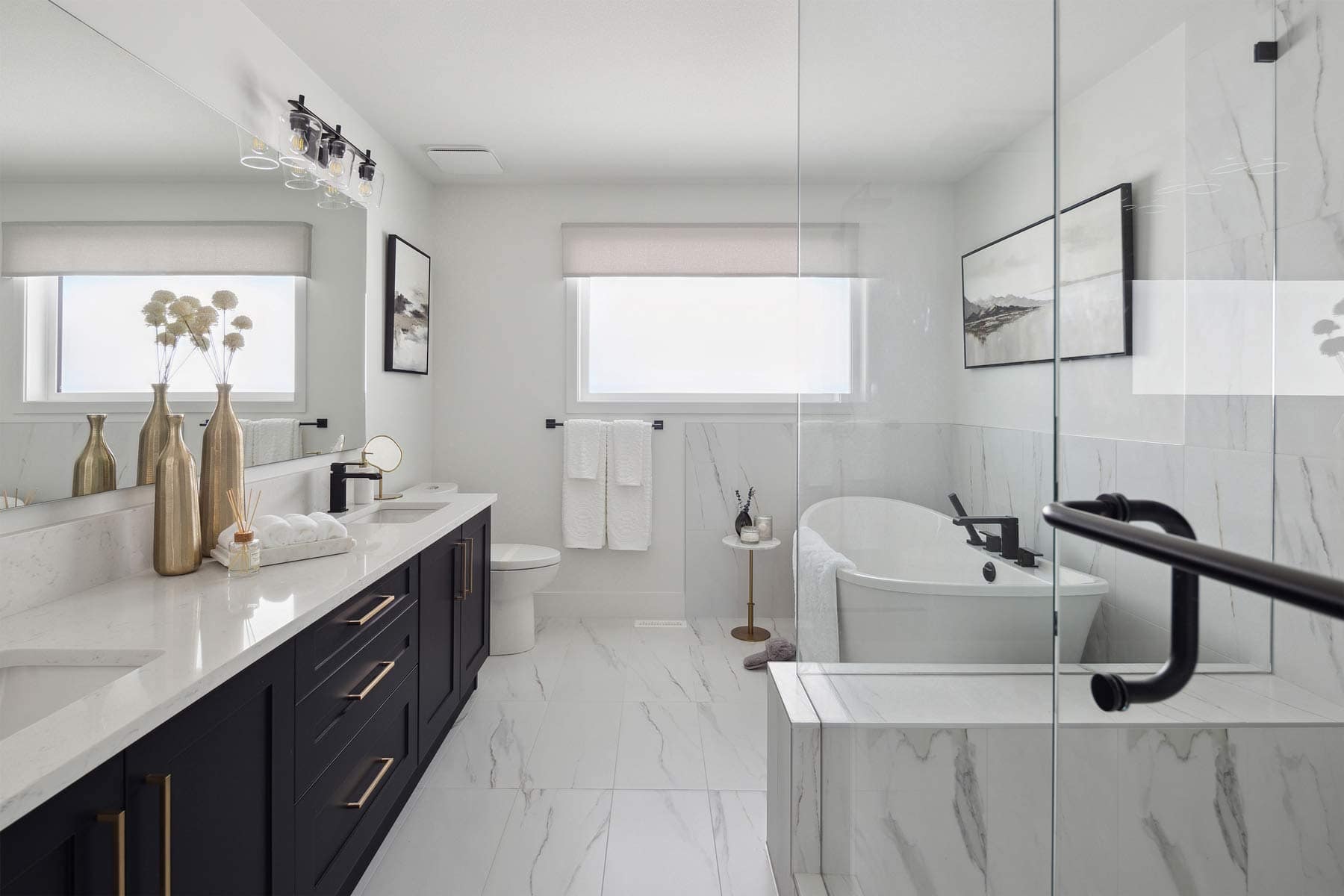 Spa-inspired bathroom at Timber's Edge Burke Mountain in Coquitlam by Foxridge Homes with freestanding tub, glass shower, double vanity, and marble-style tile finishes