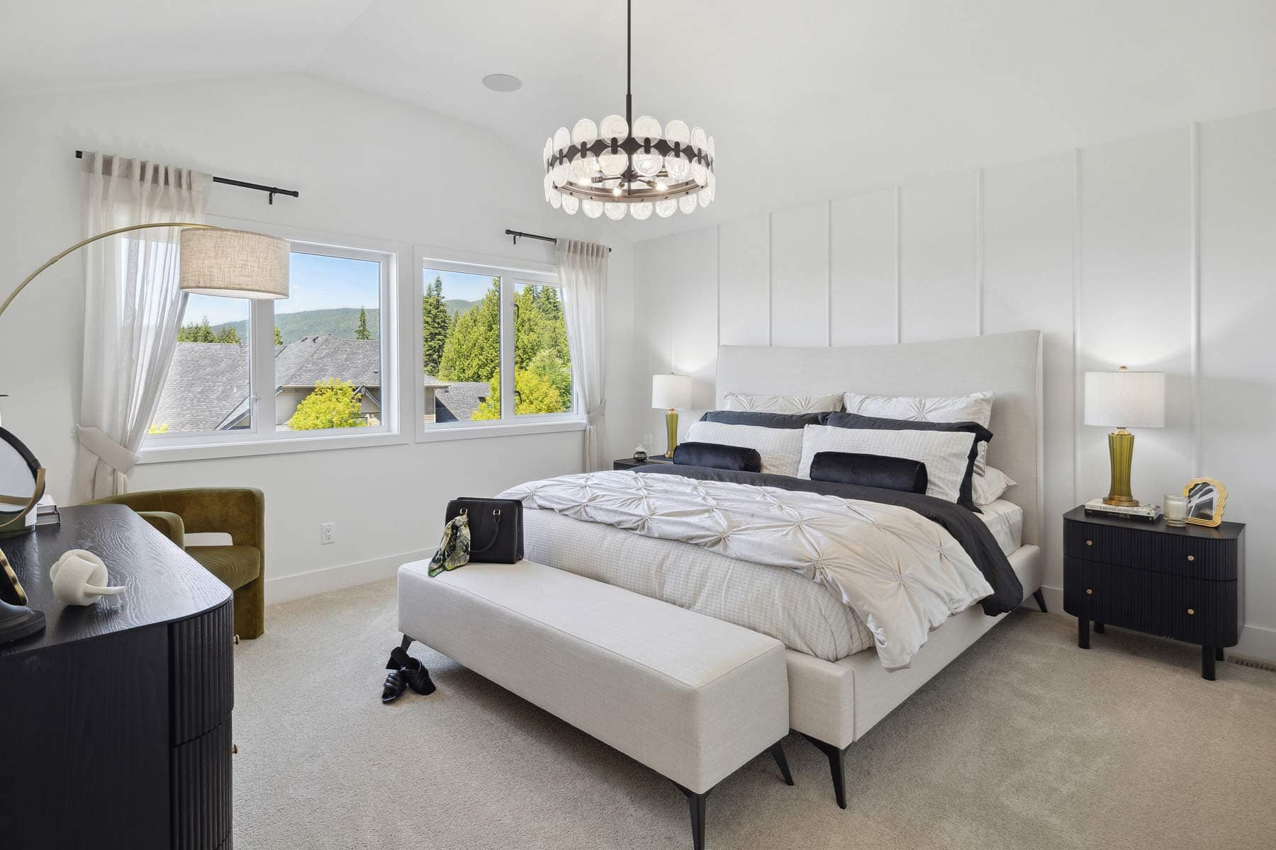 Primary bedroom at Timber's Edge Burke Mountain in Coquitlam by Foxridge Homes with large windows, soft neutral tones, and mountain and treetop views