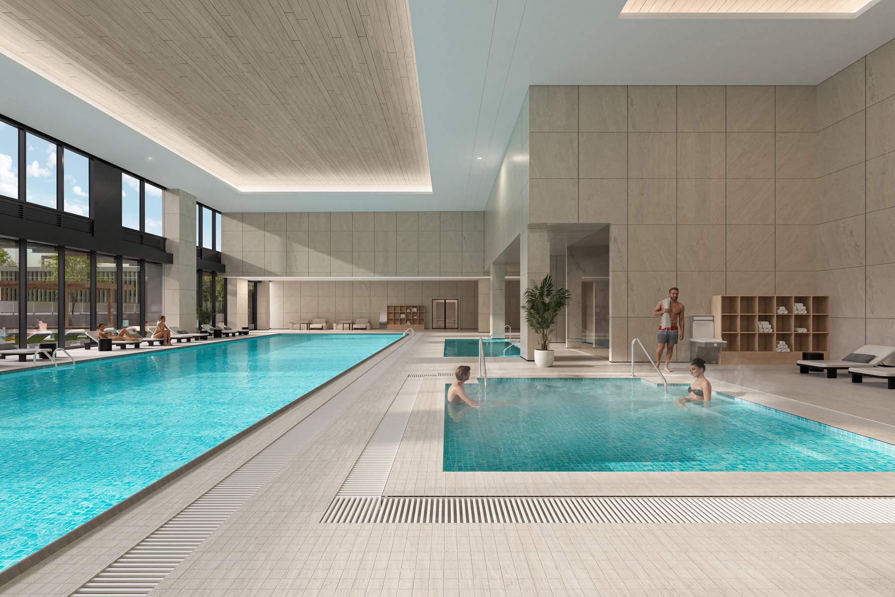 Indoor pool and hot tub area at West 57th Vancouver by Onni Group at 500 West 57th Avenue in Cambie, showing spa seating, tiled deck, and wellness-focused amenity design