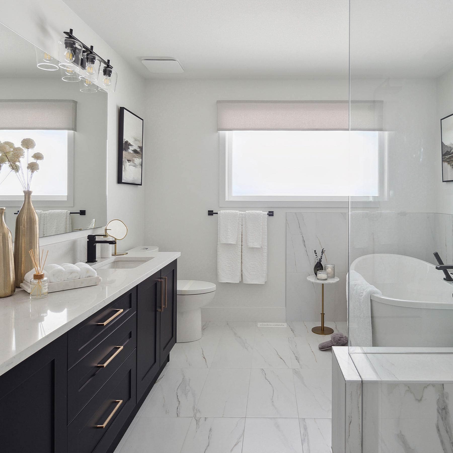 Bathroom vanity at Timber's Edge Burke Mountain in Coquitlam by Foxridge Homes with dual sinks, modern lighting, and clean contemporary finishes