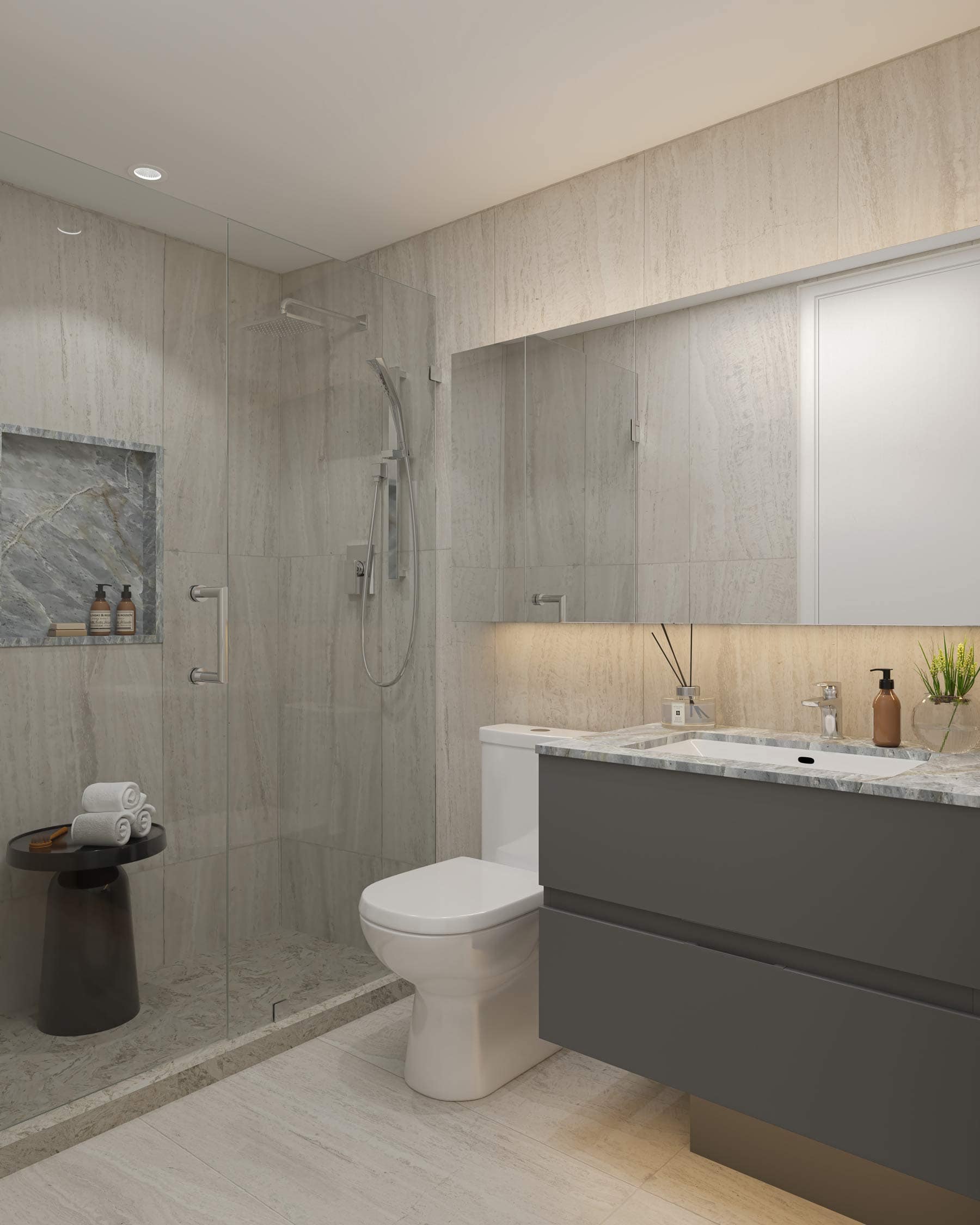 Bathroom at West 57th Vancouver by Onni Group at 500 West 57th Avenue in Vancouverโs Cambie neighbourhood, featuring a dark floating vanity, glass shower, stone surfaces, and integrated lighting