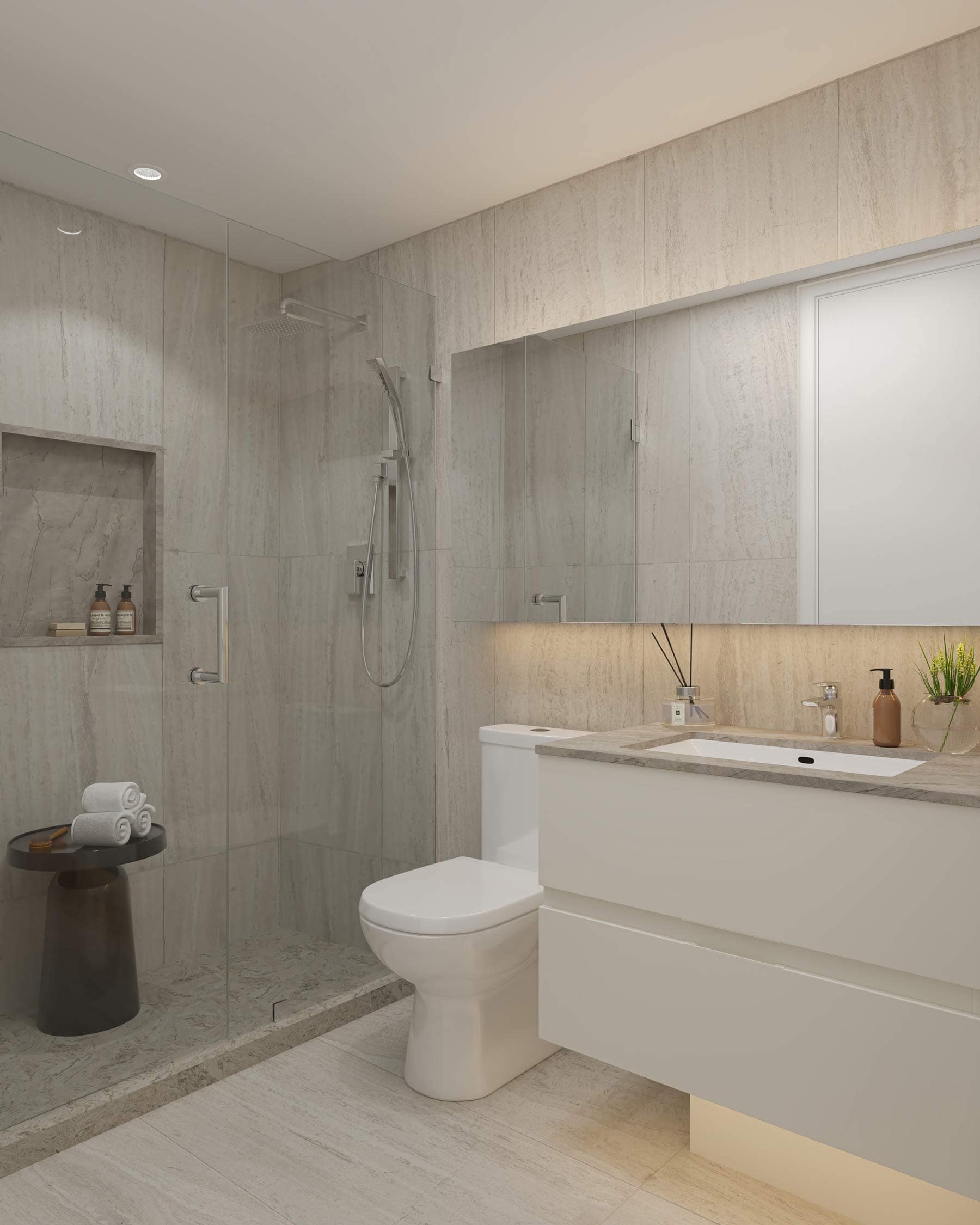 Bathroom at West 57th Vancouver by Onni Group at 500 West 57th Avenue in Cambie, featuring a light floating vanity, glass shower enclosure, stone finishes, and soft built-in lighting