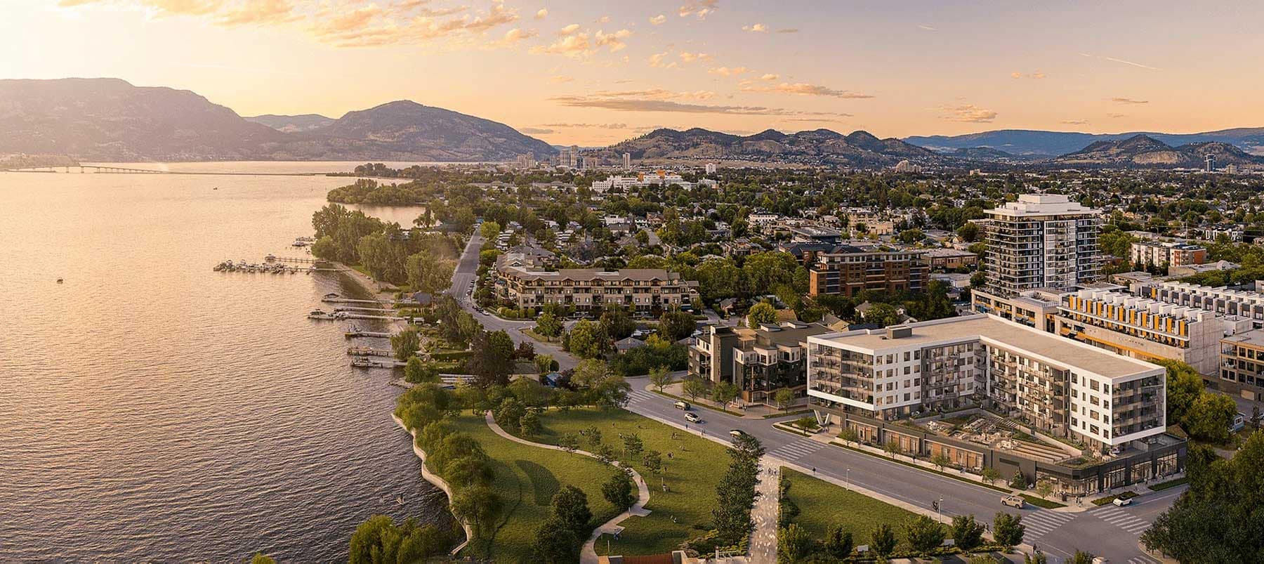 Aerial rendering of Alma Kelowna, a condominium development by Mission Group at 3051 Abbott Street, showcasing its waterfront location along Okanagan Lake, surrounding parks, nearby residential neighbourhoods, and mountain views.
