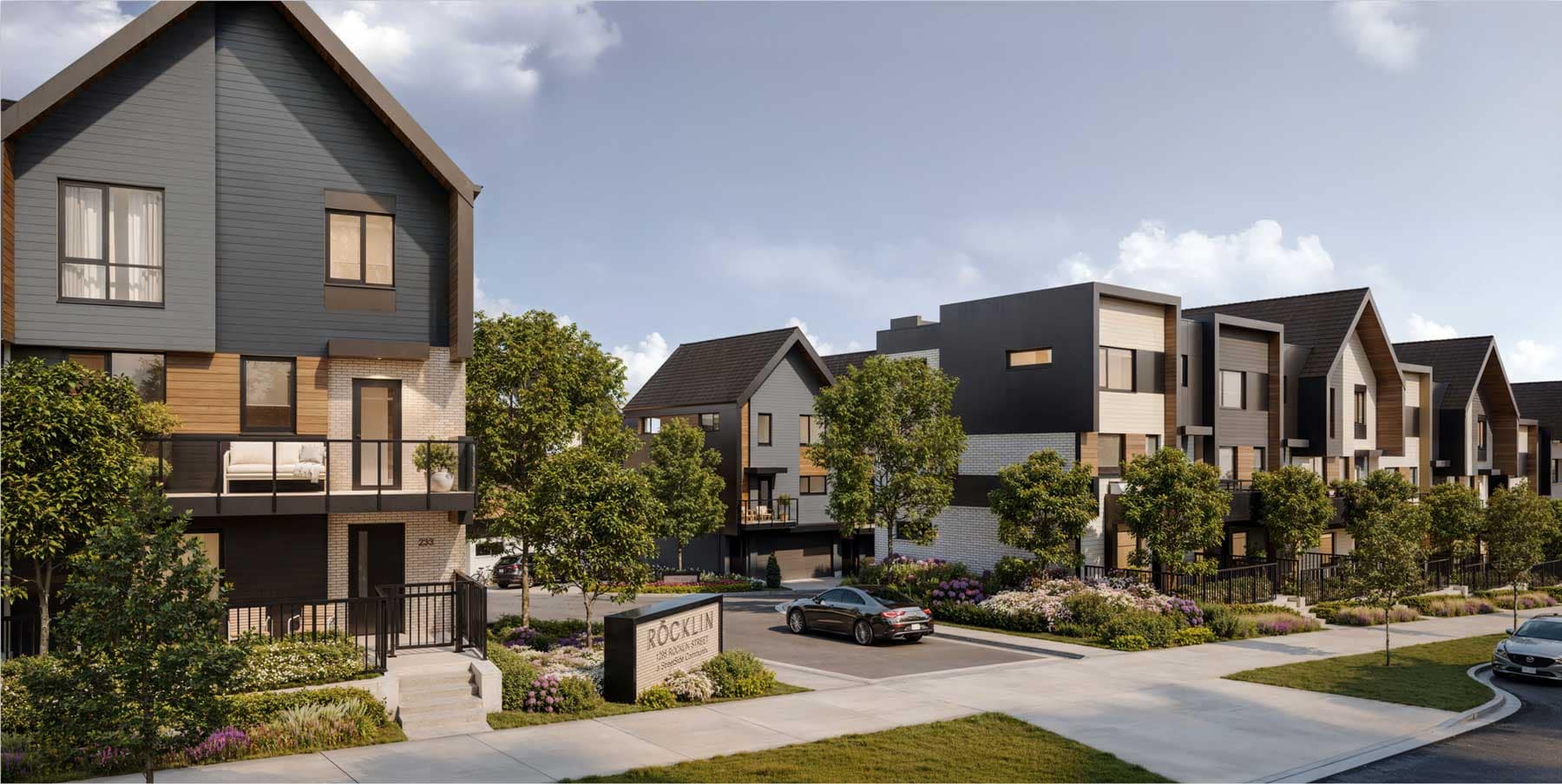 Exterior rendering of Rocklin Burke Mountain by StreetSide at 1295 Rocklin Street in Coquitlam, showing the townhome community entrance, landscaped streetscape, signage, contemporary architecture, and Burke Mountain setting.