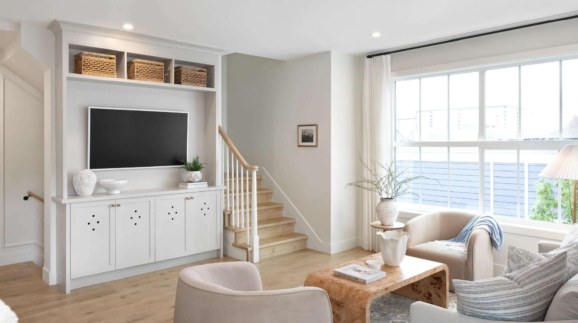 Comfortable living room at Renfrew South Langley presale development in Langleyโs Willoughby neighbourhood by CastleHill Homes at 20329 80 Avenue