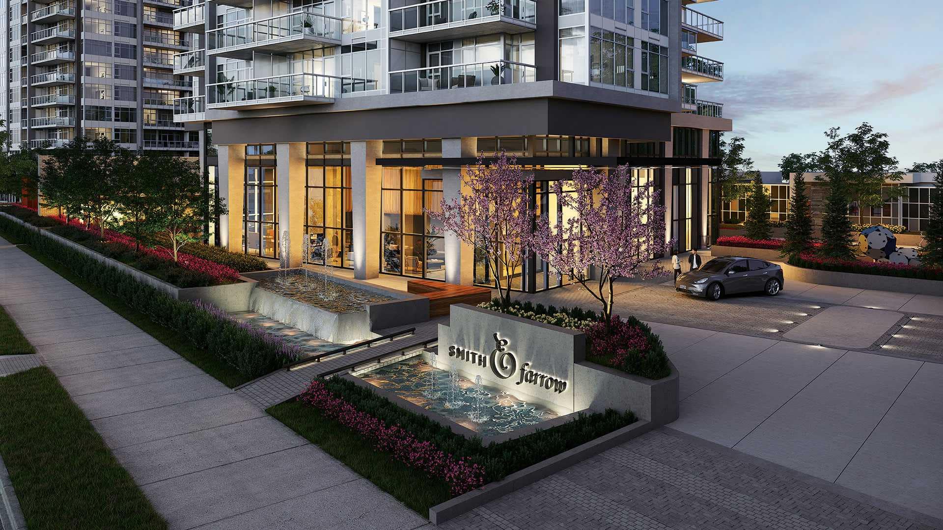 Main entrance and water feature at Smith & Farrow presale development in Coquitlam West by Boffo Developments, located at 720 Farrow Street, showcasing landscaped grounds, illuminated signage, and a refined arrival experience at the building entrance.