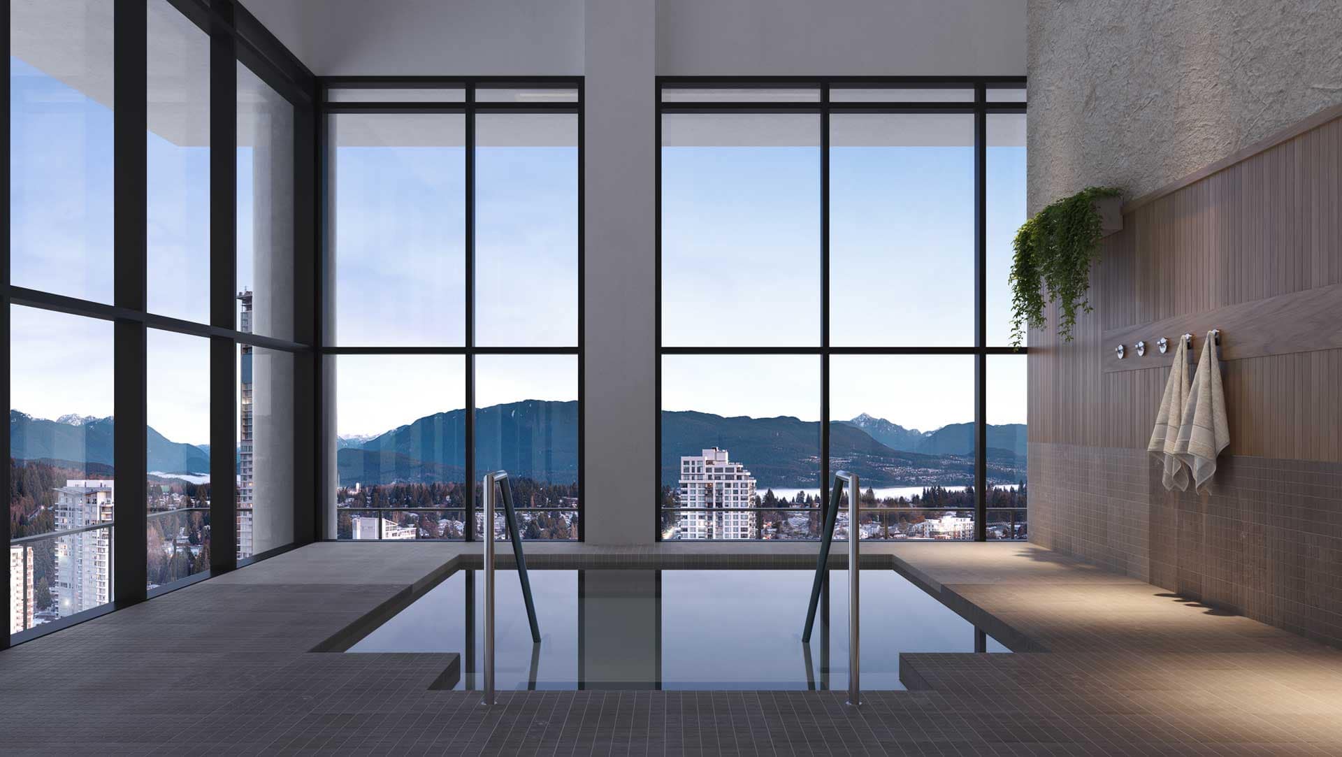 Indoor pool at Jinju Coquitlam by Anthem Properties in Burquitlam, 533 Cottonwood Avenue, featuring large windows, mountain views, and modern poolside design.