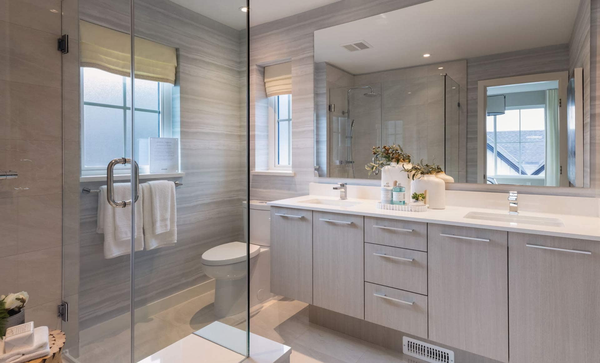 Contemporary bathroom at Ridgewood Burke Mountain in Coquitlam with double vanity, glass shower, and modern fixtures by Polygon at 3637 Sheffield Avenue.
