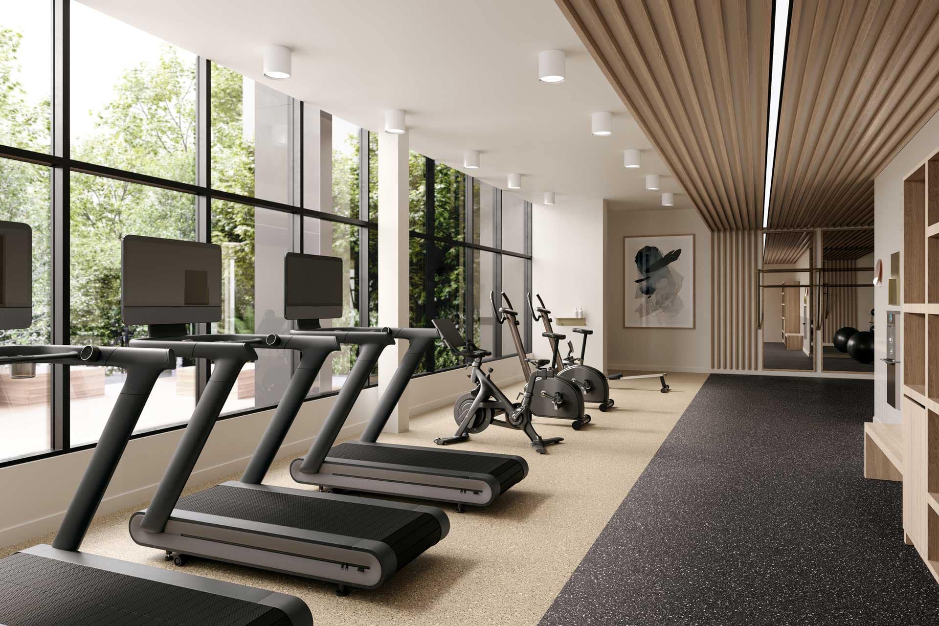 Fitness centre at Jinju Coquitlam by Anthem Properties in Burquitlam, 533 Cottonwood Avenue, featuring treadmills, stationary bikes, floor-to-ceiling windows, and modern workout space overlooking greenery.