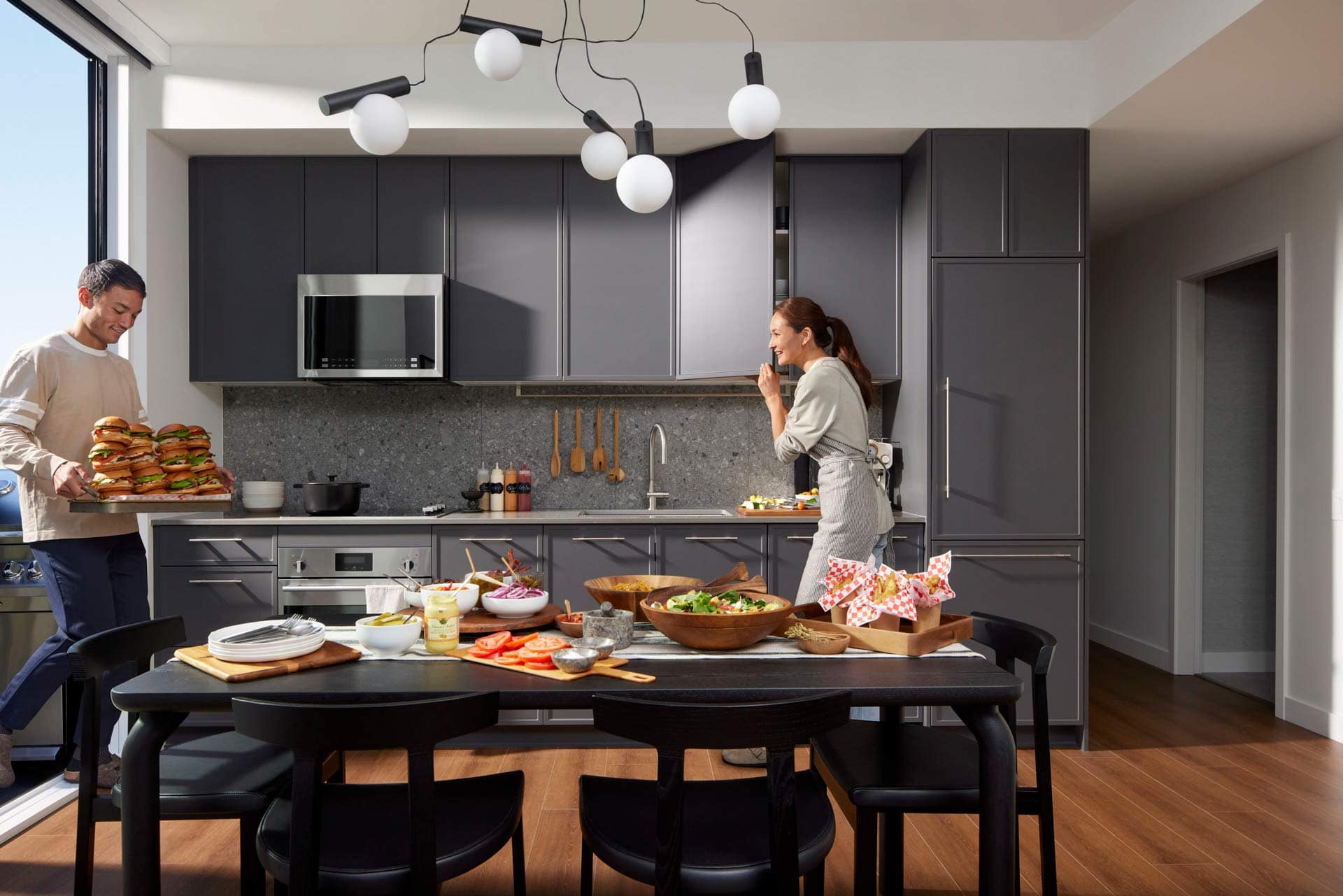 Dark-themed kitchen interior at Town & Centre by Mosaic in Coquitlam Town Centre featuring modern cabinetry, island, and high-end finishes at 3650 Westwood Street