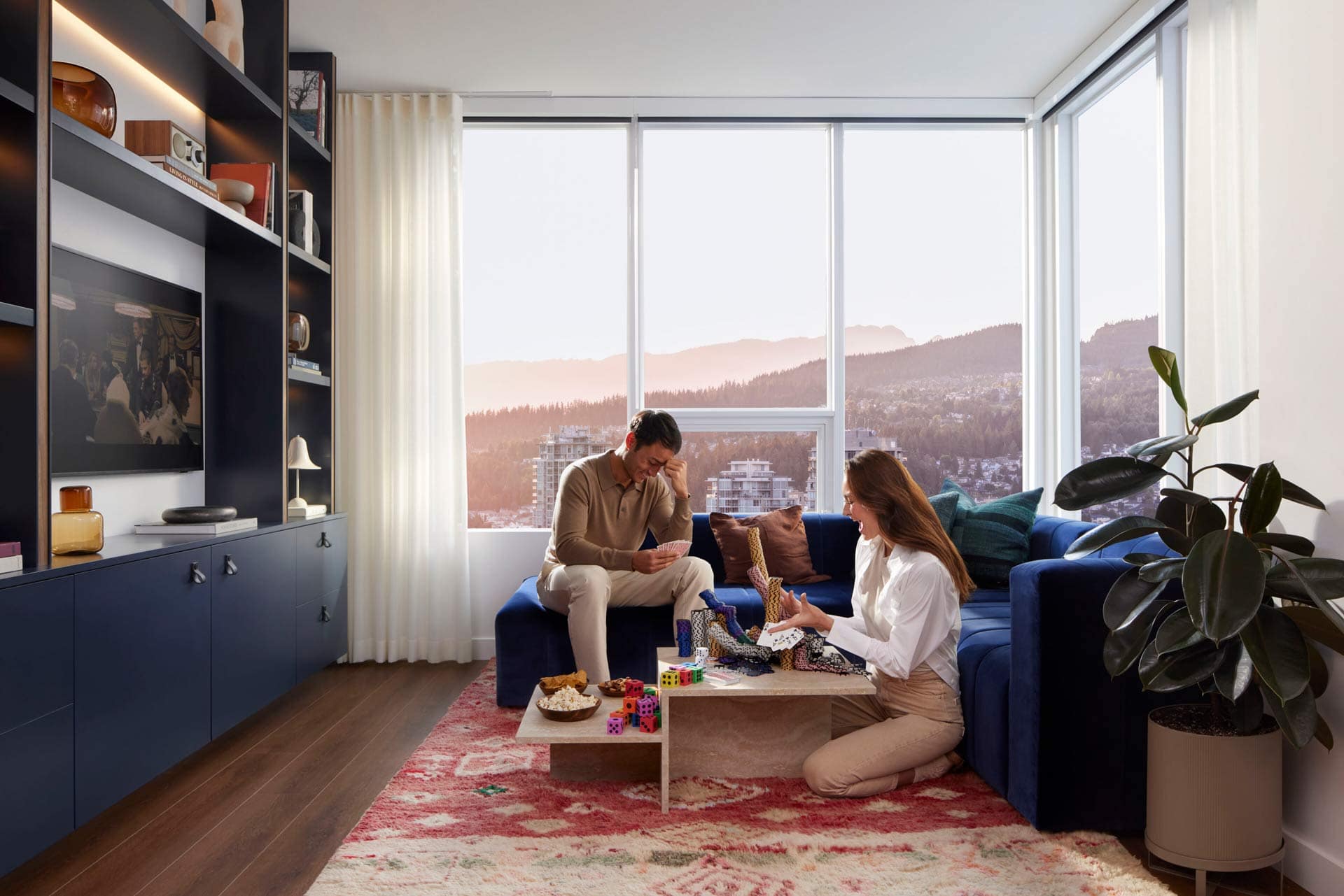 Spacious living room at Town & Centre by Mosaic in Coquitlam Town Centre with floor-to-ceiling windows, modern furnishings, and city views at 3650 Westwood Street