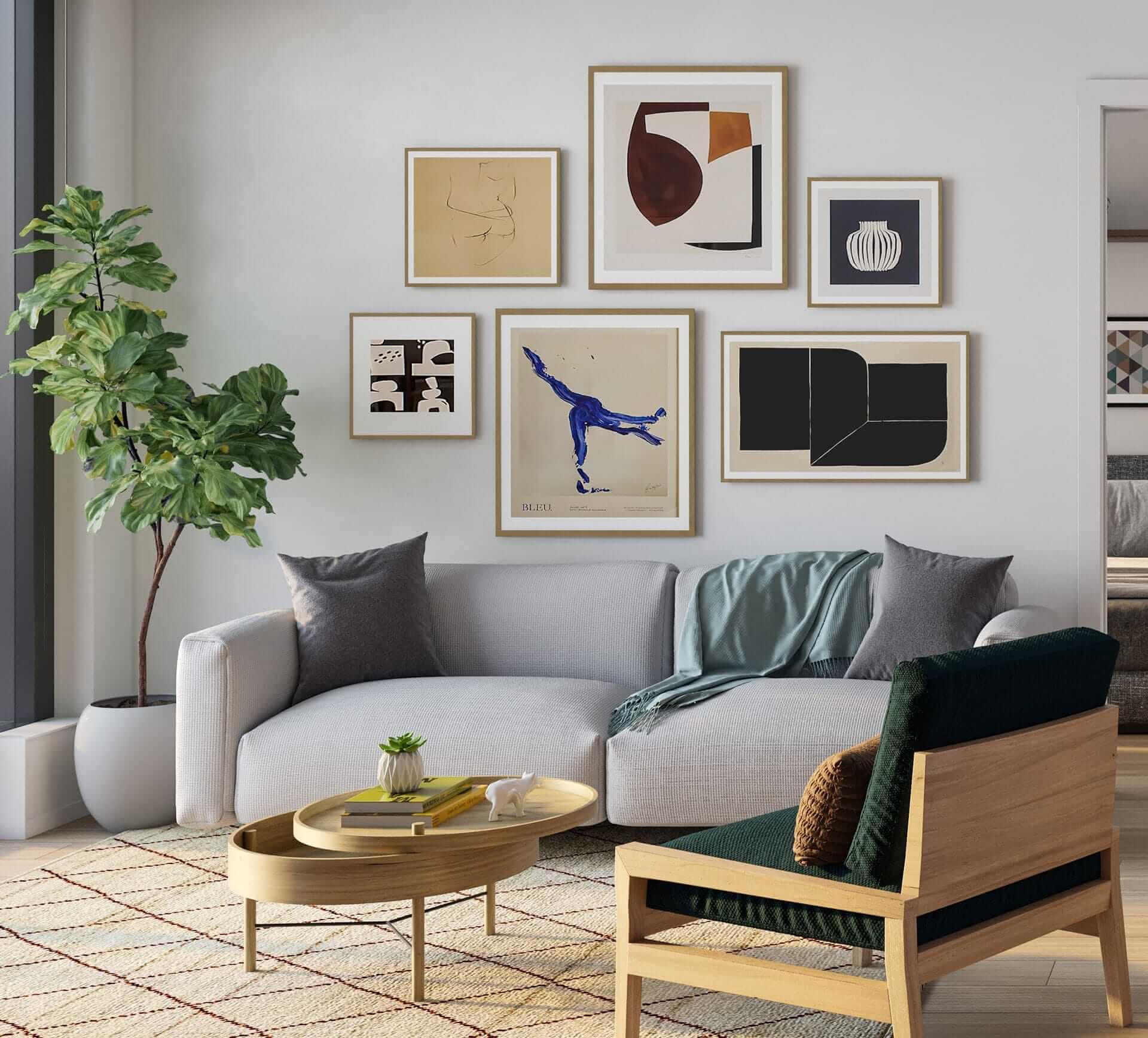 Bright living room at Frame Vancouver presale in Collingwood with a modern sofa, curated gallery wall, indoor plant, and minimalist furniture design by Peterson at 5189 Earles Street.