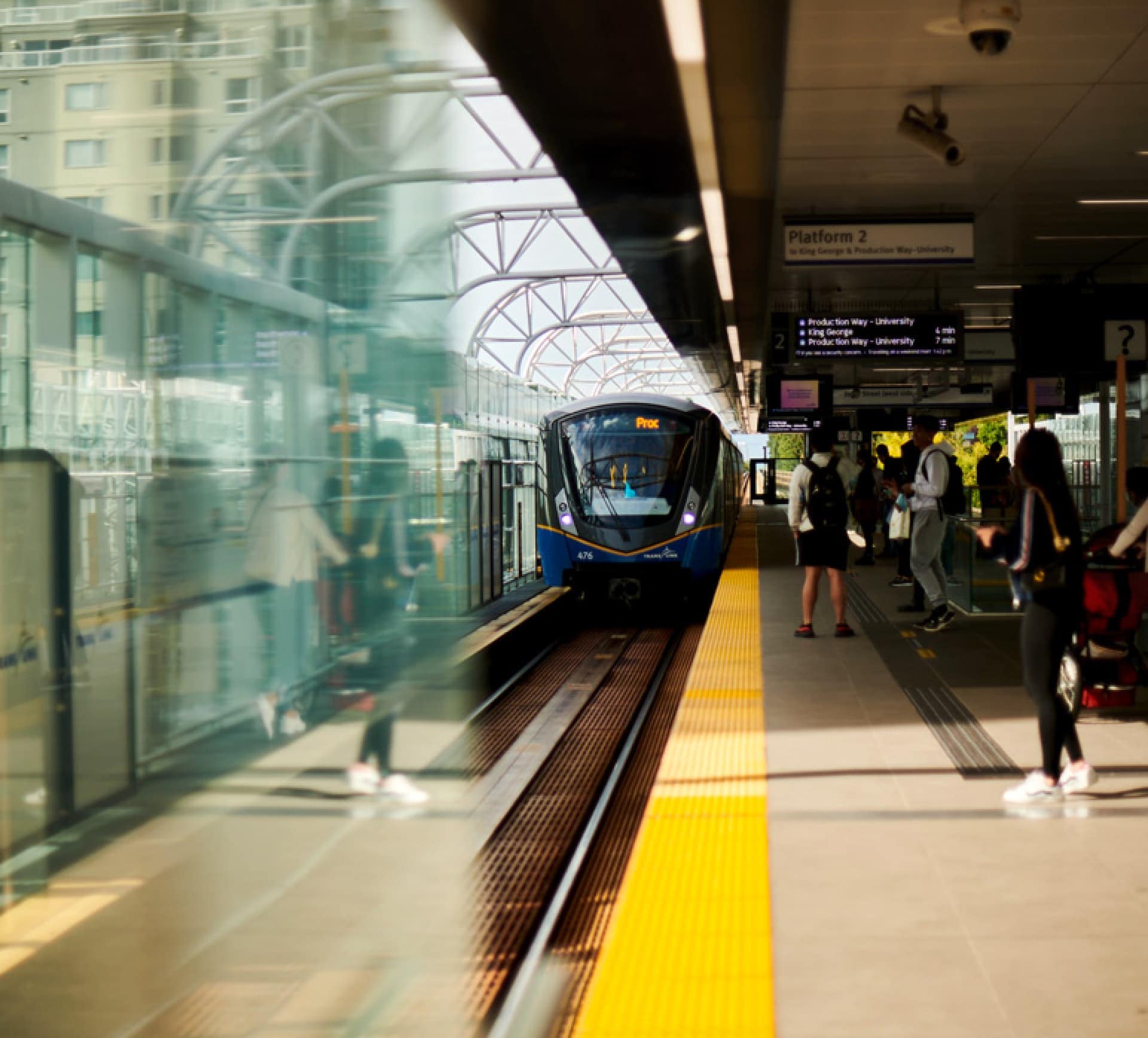 SkyTrain station near Frame Vancouver presale at 5189 Earles Street showing convenient transit access in Collingwood with passengers and train platform.