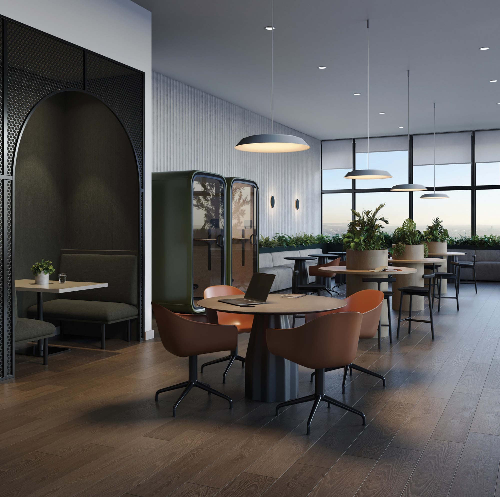Co-working lounge at Reign Metrotown with work pods, tables, and large windows.