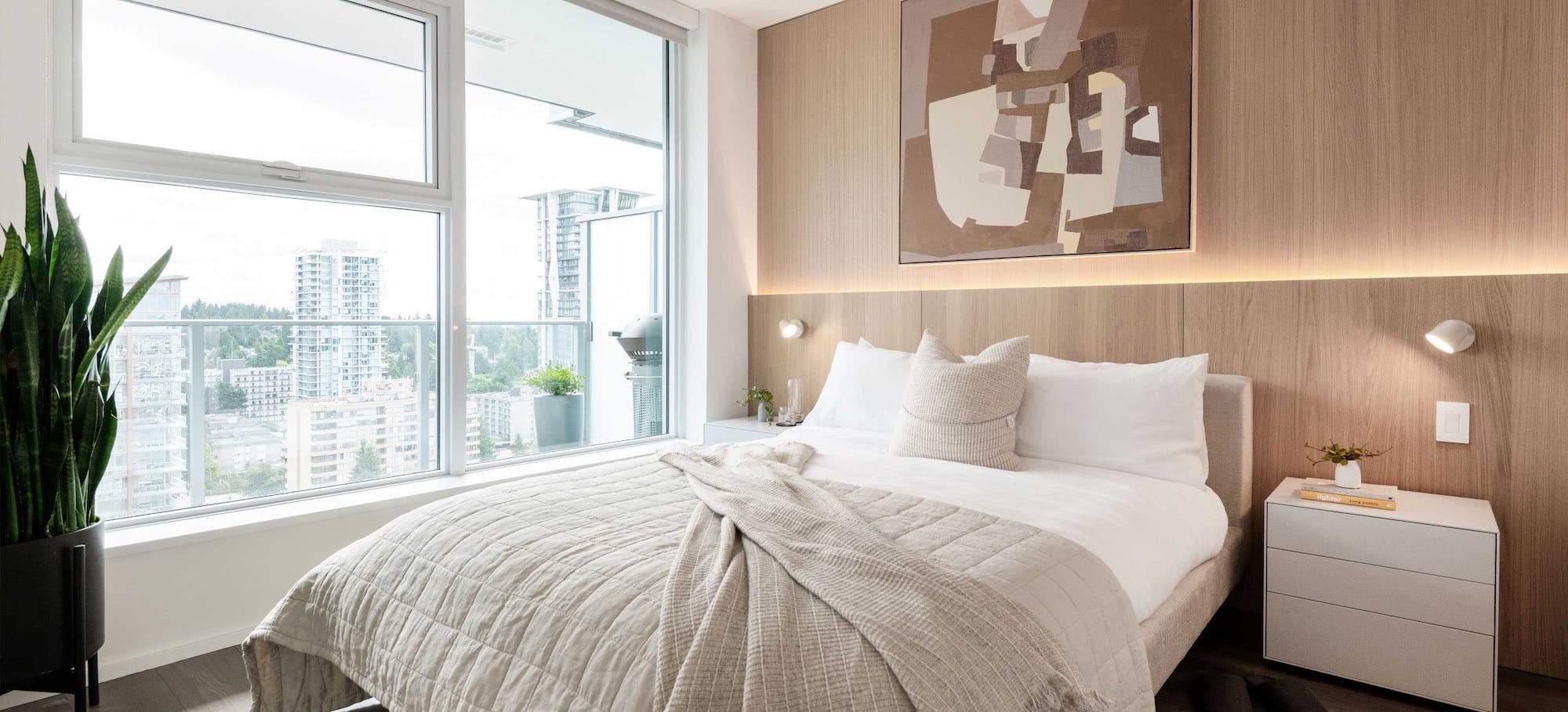 Primary bedroom with city views at The City of Lougheed Burnaby condos