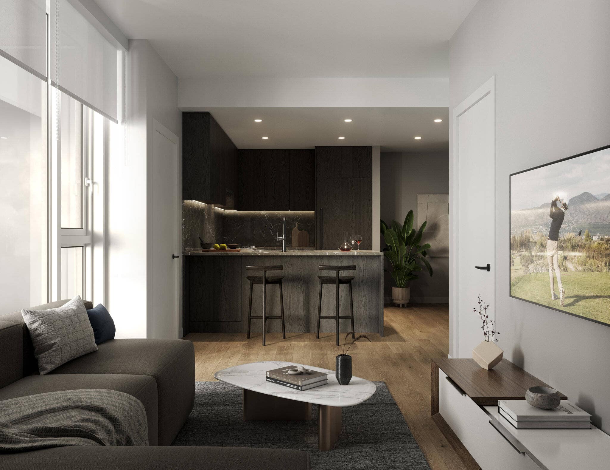 Dark contemporary kitchen at Reign Metrotown with open living area and TV wall.