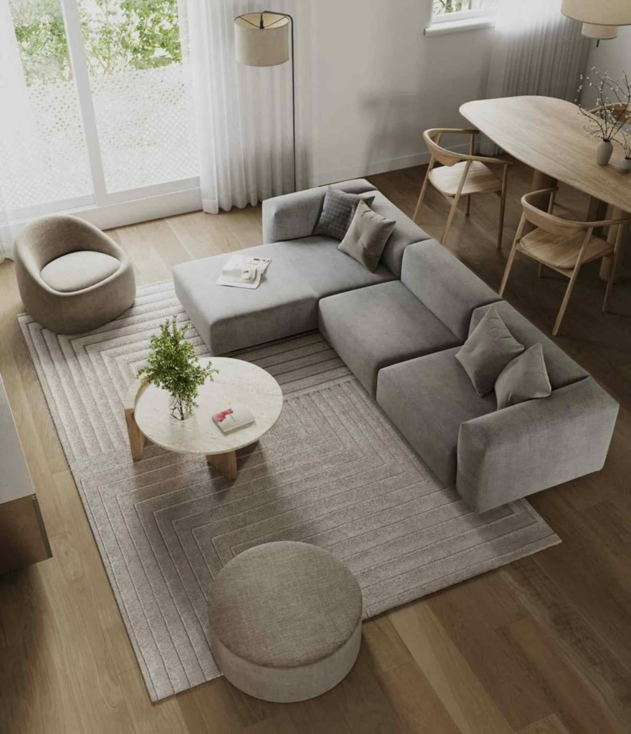 Stylish living and dining area inside Hendry presale homes in East Vancouver, featuring European minimalism, neutral colour palette, wood flooring, modern furnishings, and expansive windows at 3839 Commercial Street by Trillium Projects.