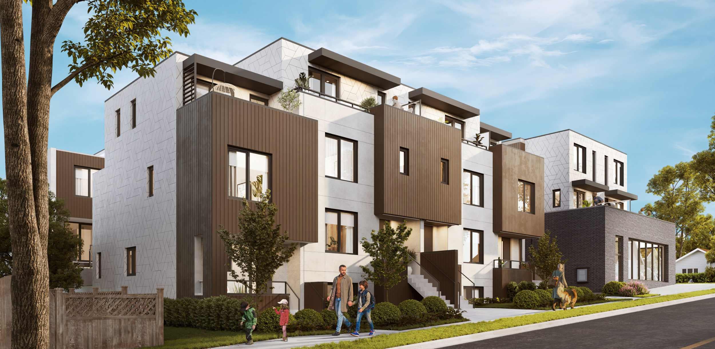 Exterior view of Lakewood townhomes in Vancouverโs Grandview neighbourhood, developed by Dimex Group, highlighting modern multi-level architecture, landscaped walkways, and a family-friendly streetscape at 2057 East 1st Avenue.