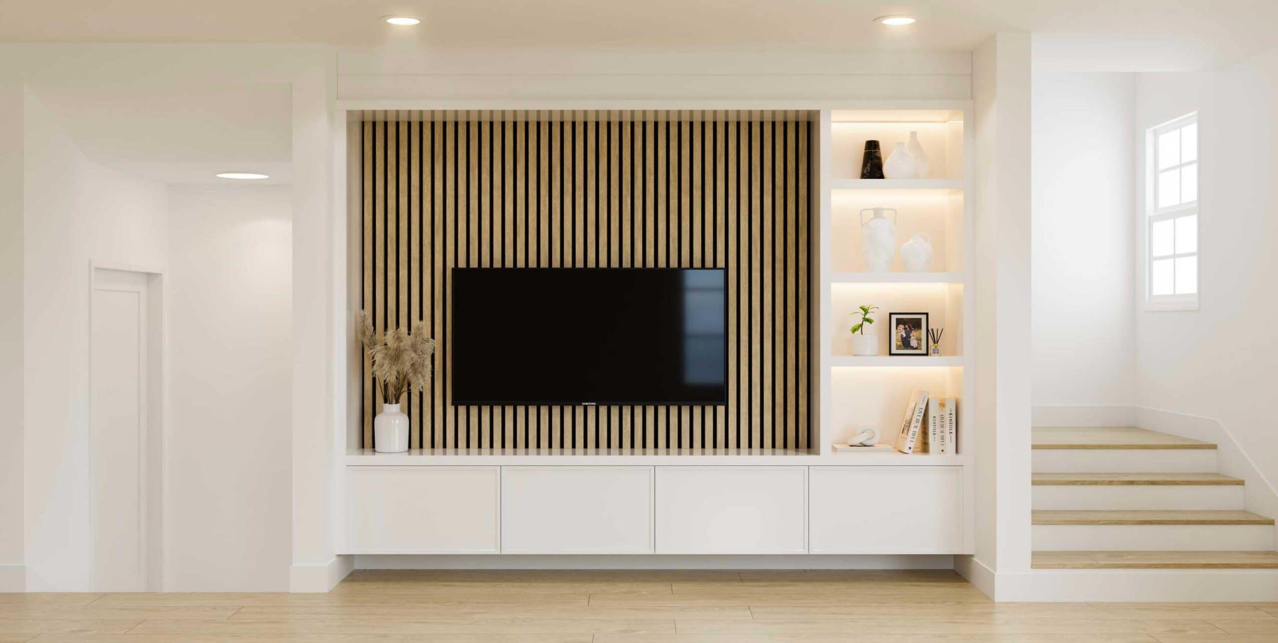 Contemporary living room entertainment wall at Fiore Langley featuring custom built-in shelving, wood slat accent detailing, mounted television, recessed lighting, and modern finishes by Front Lane Developments at 8039 197 Street in Langley.