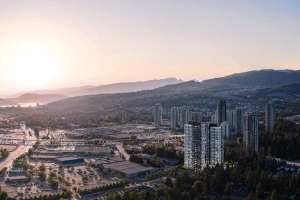 Aerial view of Coquitlam Town Centre near Town & Centre by Mosaic at 3650 Westwood Street in Port Coquitlam, showing high-rise buildings, shopping areas, and mountain backdrop at sunset
