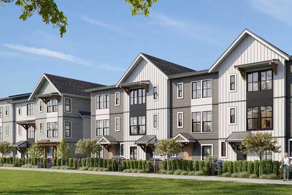 Exterior view of Heath West townhomes in Langley’s Willoughby neighbourhood at 7918 204B Street developed by BMG Real Estate, featuring modern farmhouse architecture with pitched rooflines, fibre cement siding, black-framed windows, landscaped pathways, and rows of contemporary three-storey townhomes overlooking green space.