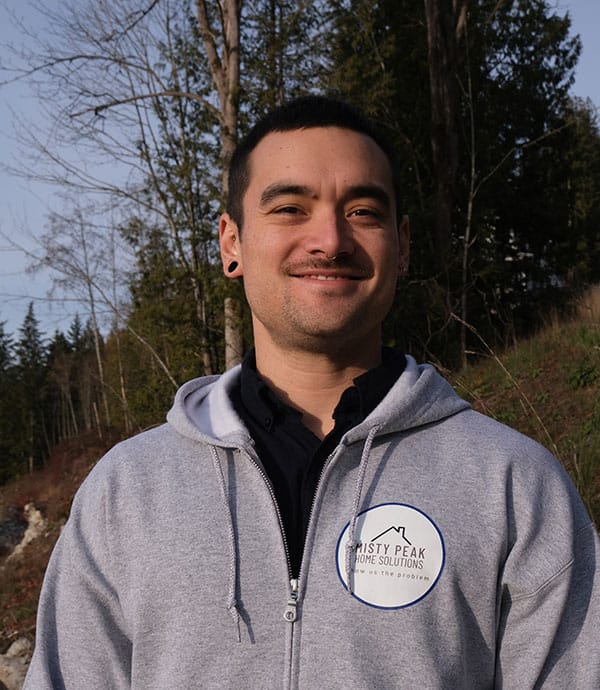 Casual portrait of Isaiah Tuason-Brignall, service technician and owner of Misty Home Solutions, smiling in an outdoor setting.