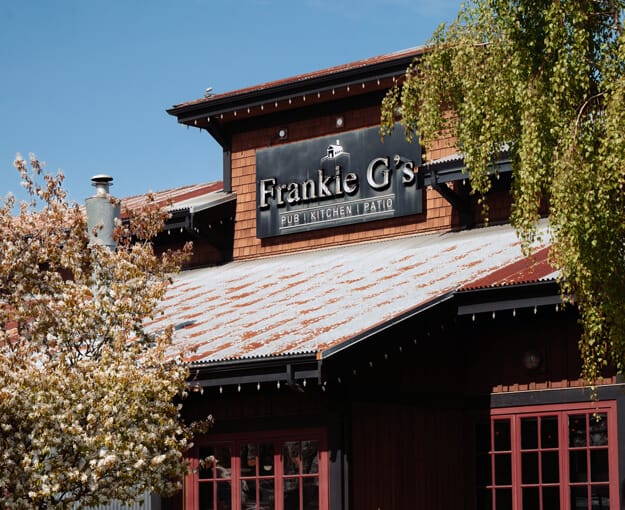 Exterior of Frankie G's Pub Kitchen Patio in Queensborough New Westminster located near Mercer Village New Westminster by Domus Homes at 388 Duncan Street. The building features rustic wood architecture and signage representing local dining options and neighbourhood amenities available to Mercer Village residents.