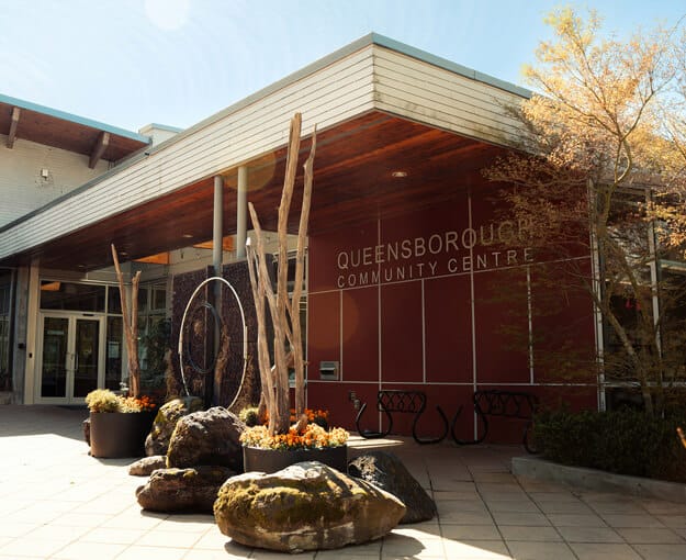 Exterior of Queensborough Community Centre in New Westminster located near Mercer Village New Westminster by Domus Homes at 388 Duncan Street. The modern building features wood and glass architectural elements