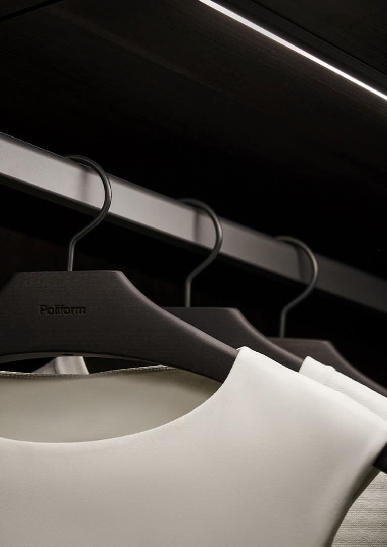 Tesoro Vancouver Poliform closet detail with wooden hangers and LED lighting