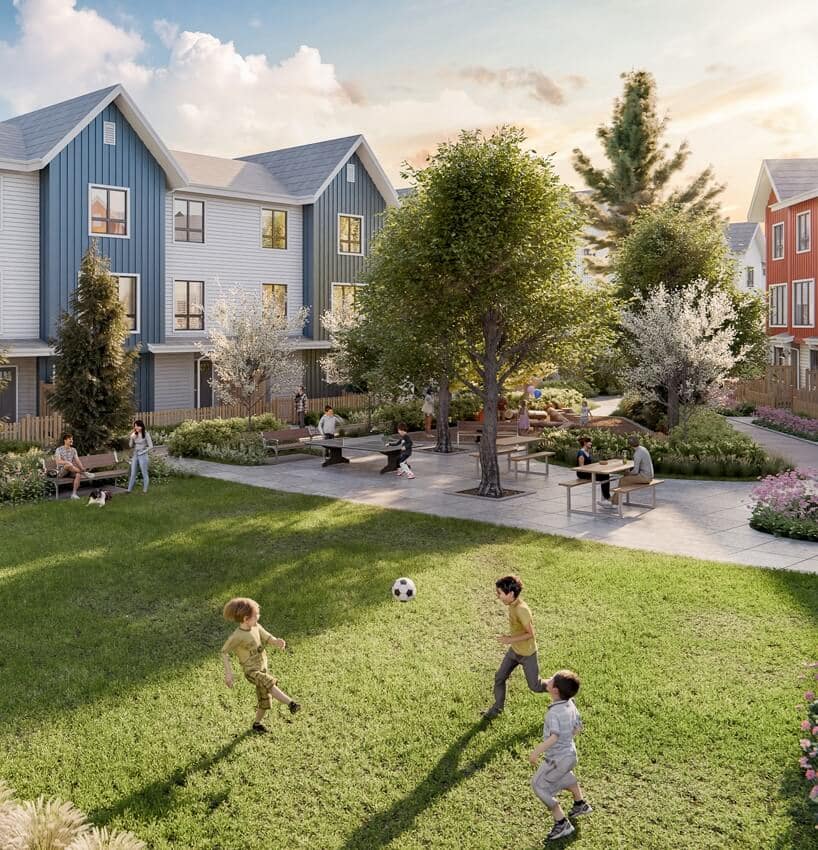 Landscaped courtyard green space at Mercer Village New Westminster by Domus Homes located at 388 Duncan Street in Queensborough New Westminster. Children play on the lawn while residents relax at seating areas surrounded by modern townhomes