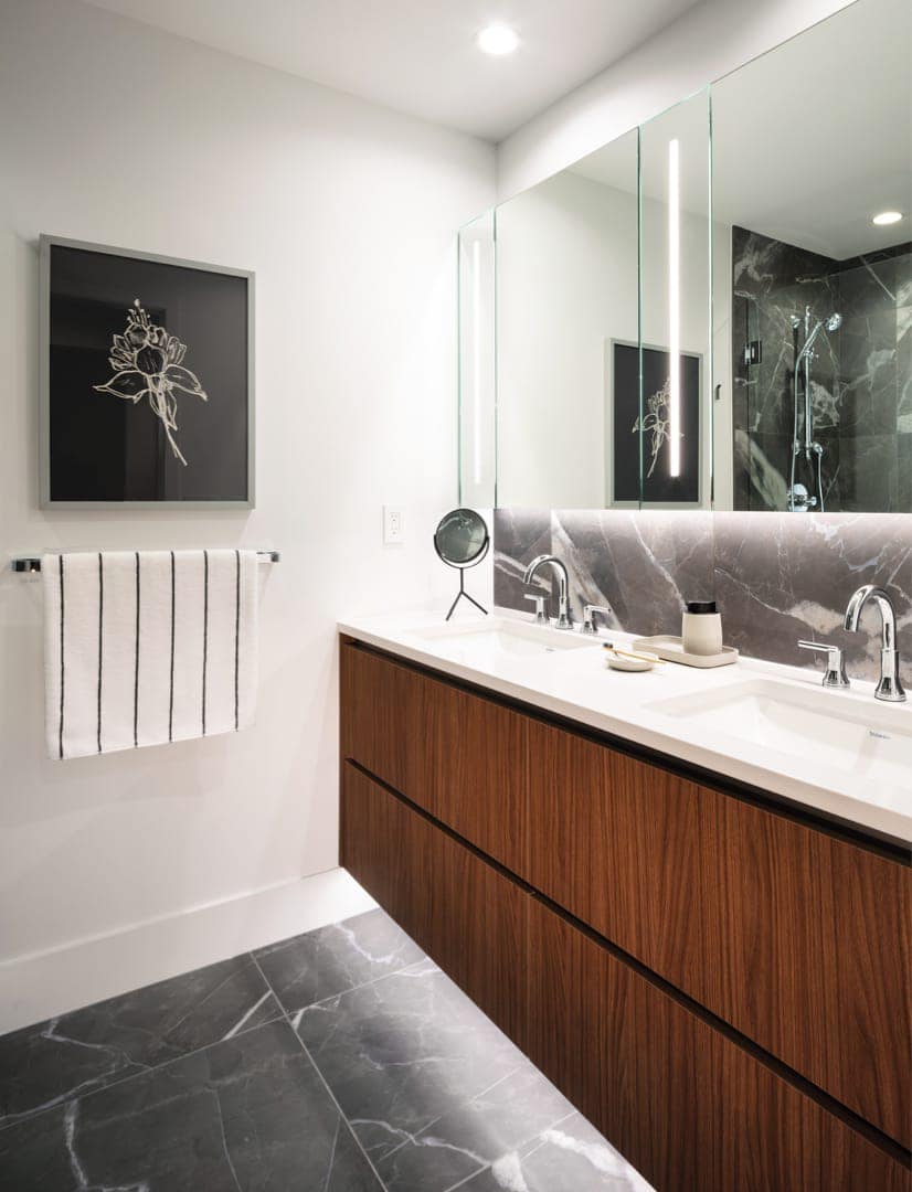 Double vanity bathroom at Smith & Farrow presale in Coquitlam West by Boffo Developments, located at 720 Farrow Street, featuring wood-tone cabinetry, quartz counters, integrated mirror lighting, and contemporary fixtures in a bright, modern layout.